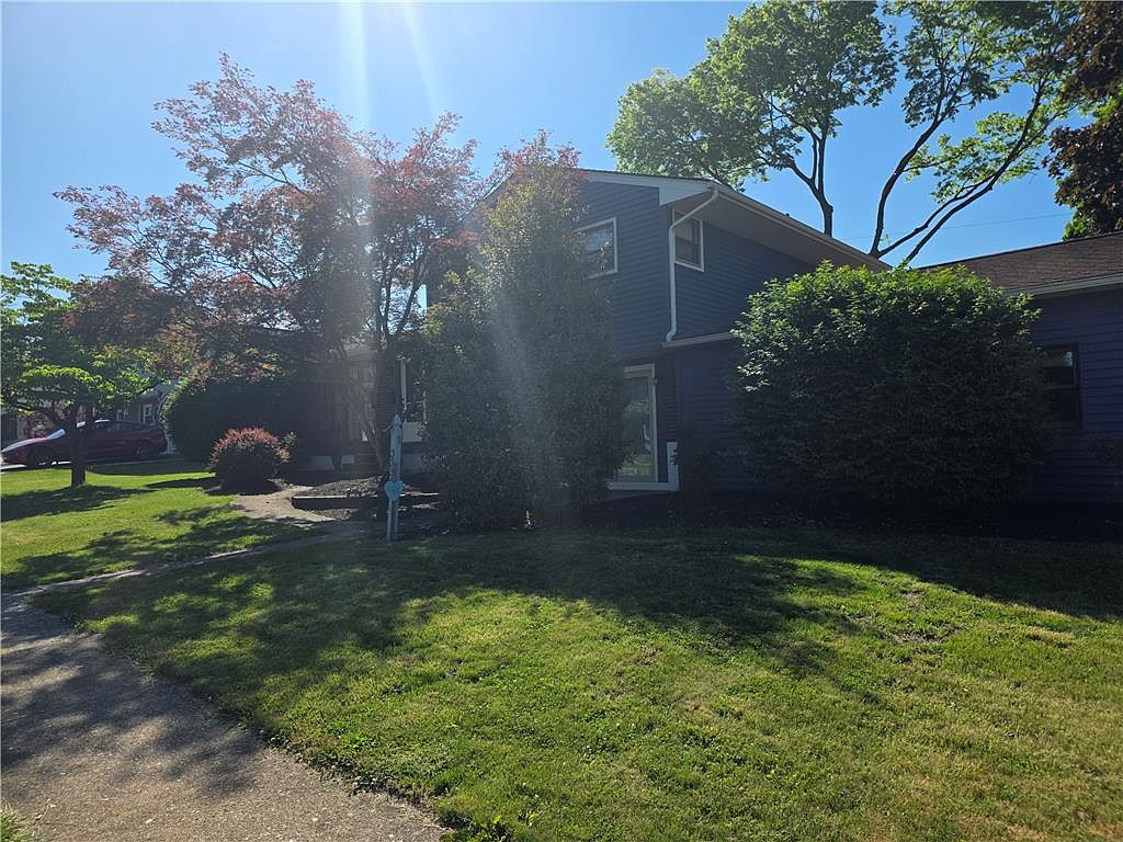 Front exterior of 3334 Thomas St, Whitehall PA — a traditional blue two-story home with mature landscaping