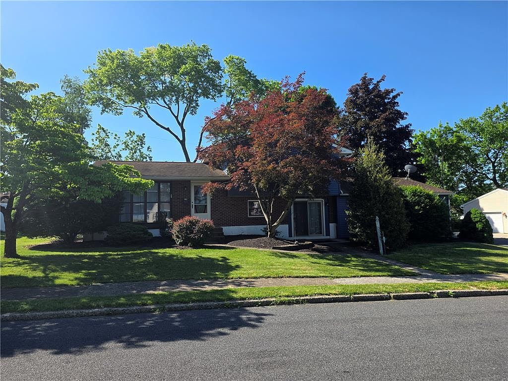Front facade of 3334 Thomas St with mature landscaping