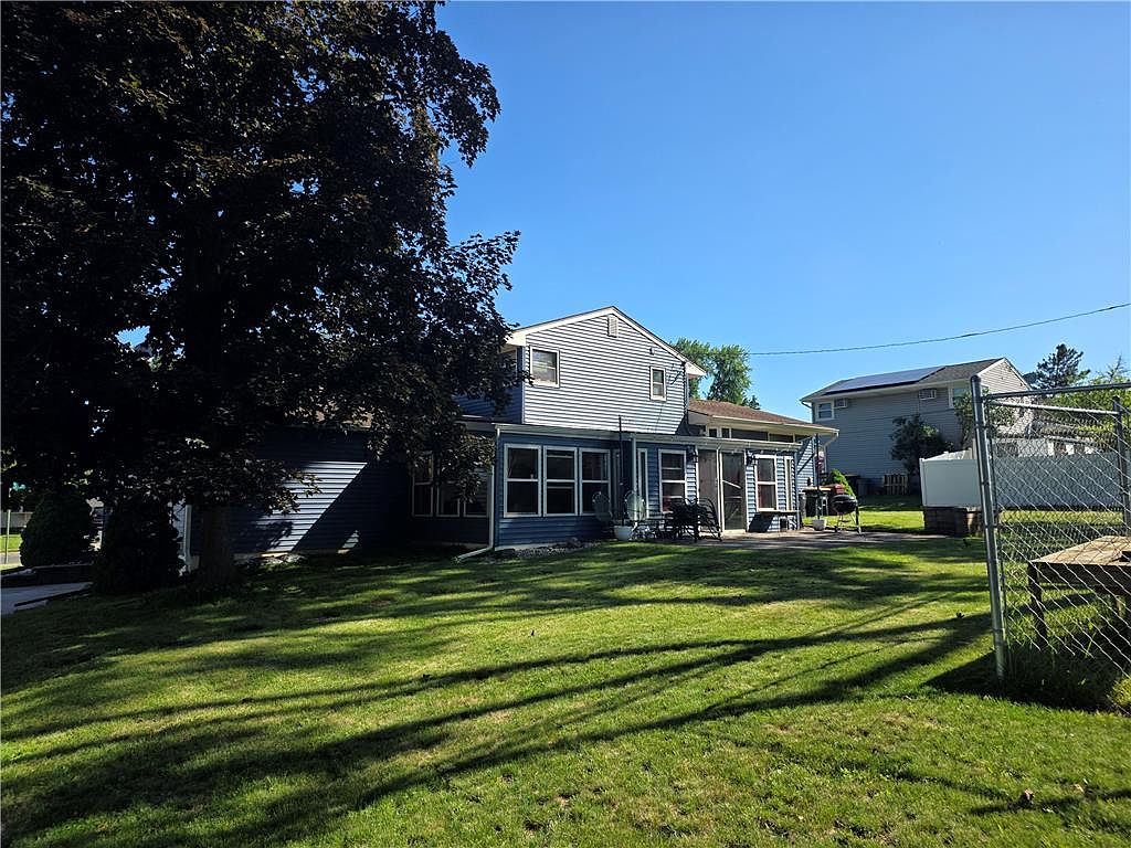 Spacious backyard with mature landscaping and patio