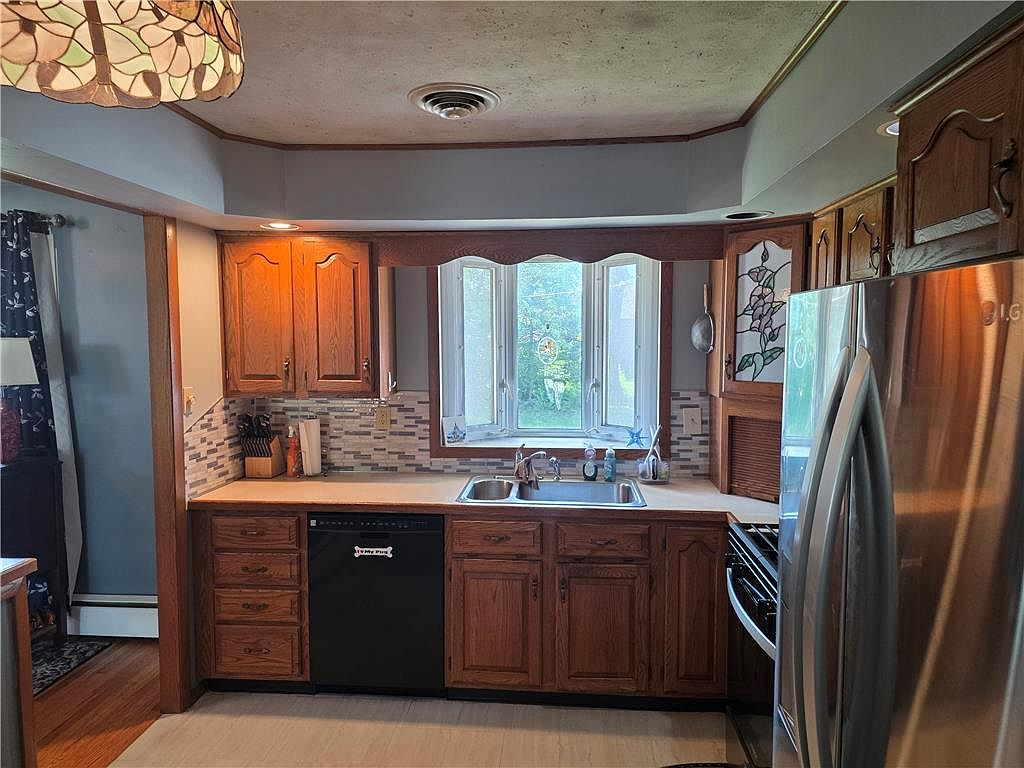 Eat-in kitchen with oak cabinetry and bay window