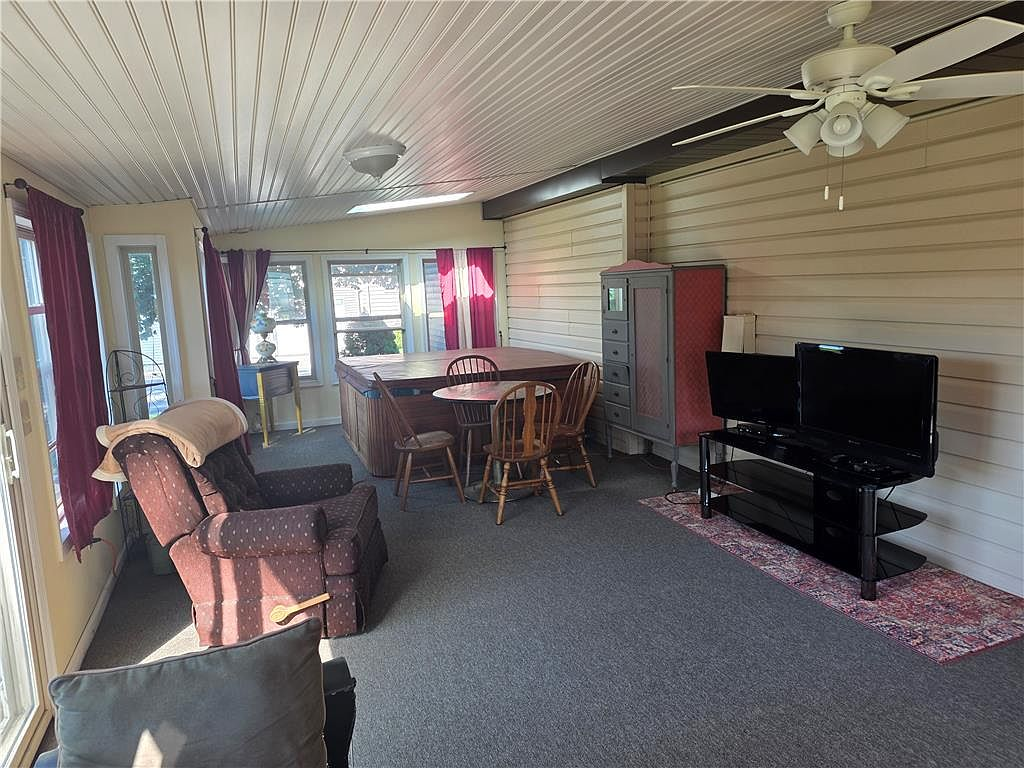 Four-season sunroom with skylights and hot tub