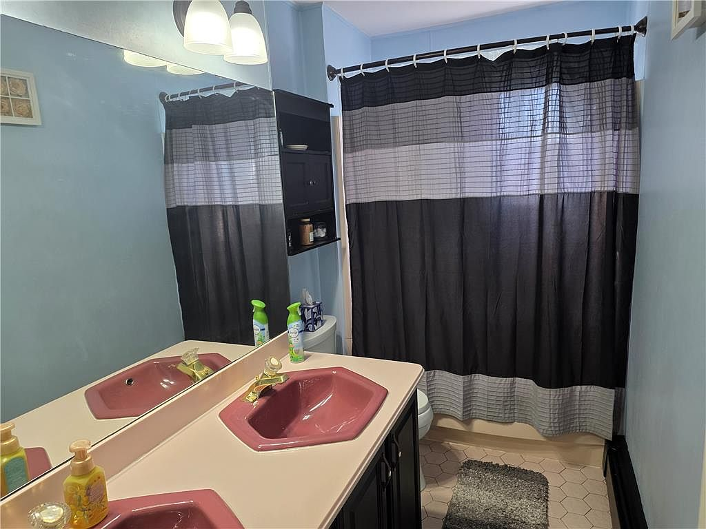 Bathroom with dual vanity and mirror