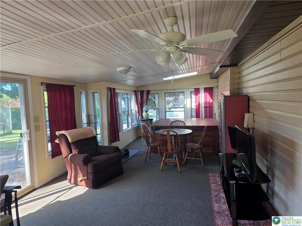 Sunroom with hot tub and ceiling beams