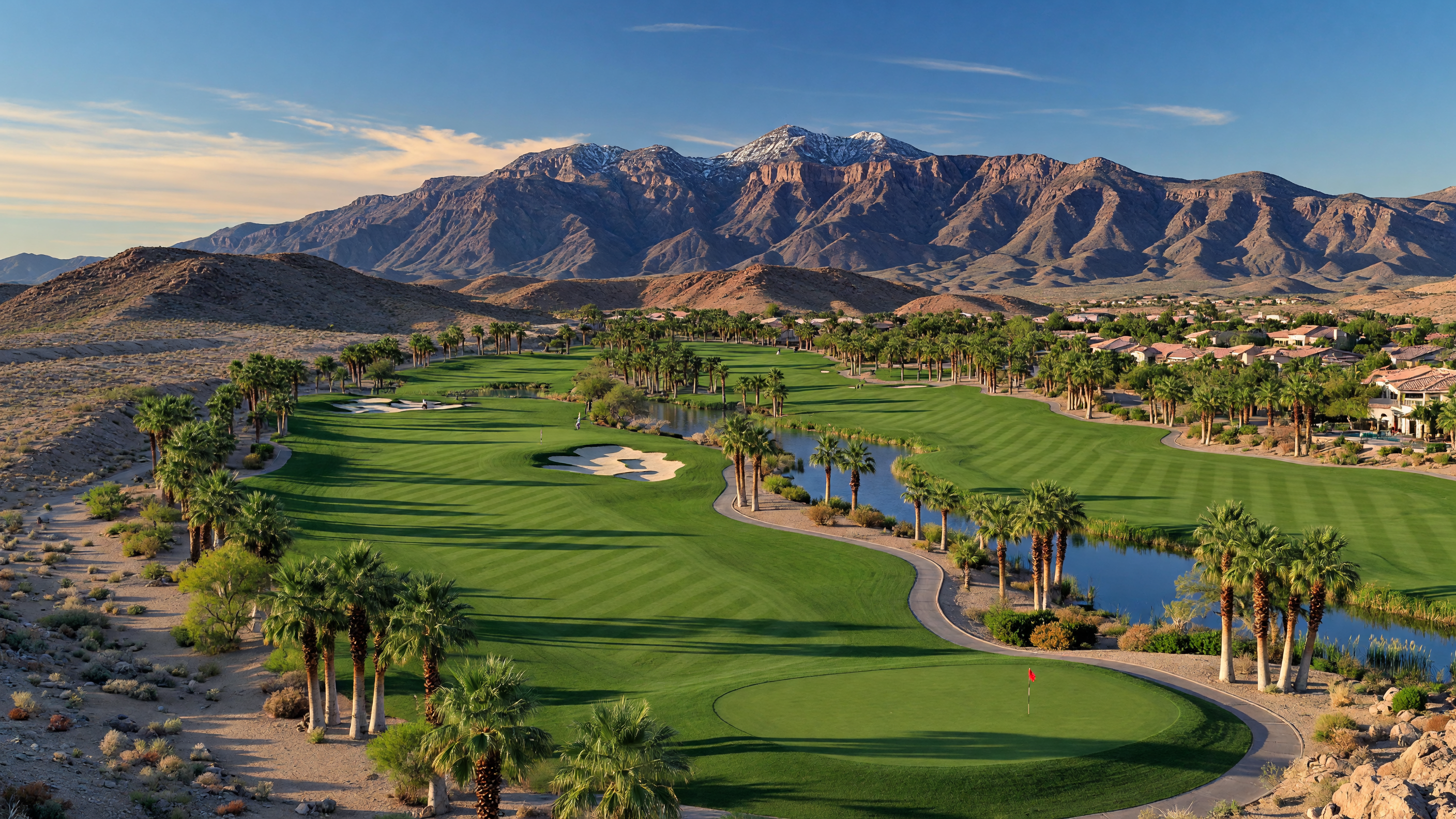 Rhodes Ranch Golf Club fairways with water features and Spring Mountain backdrop