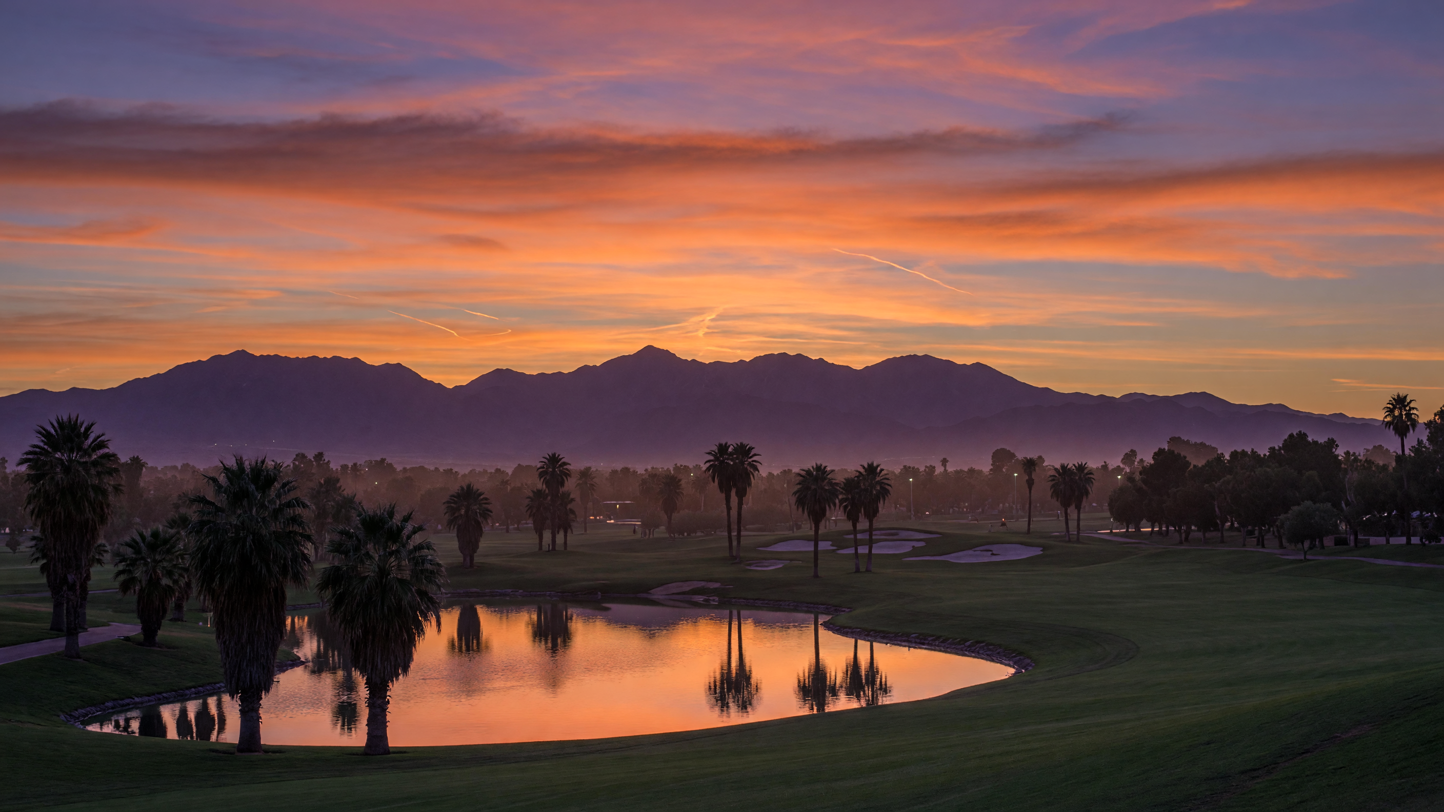 Gorgeous sunset over Rhodes Ranch Golf Club with mountains painted in orange and pink