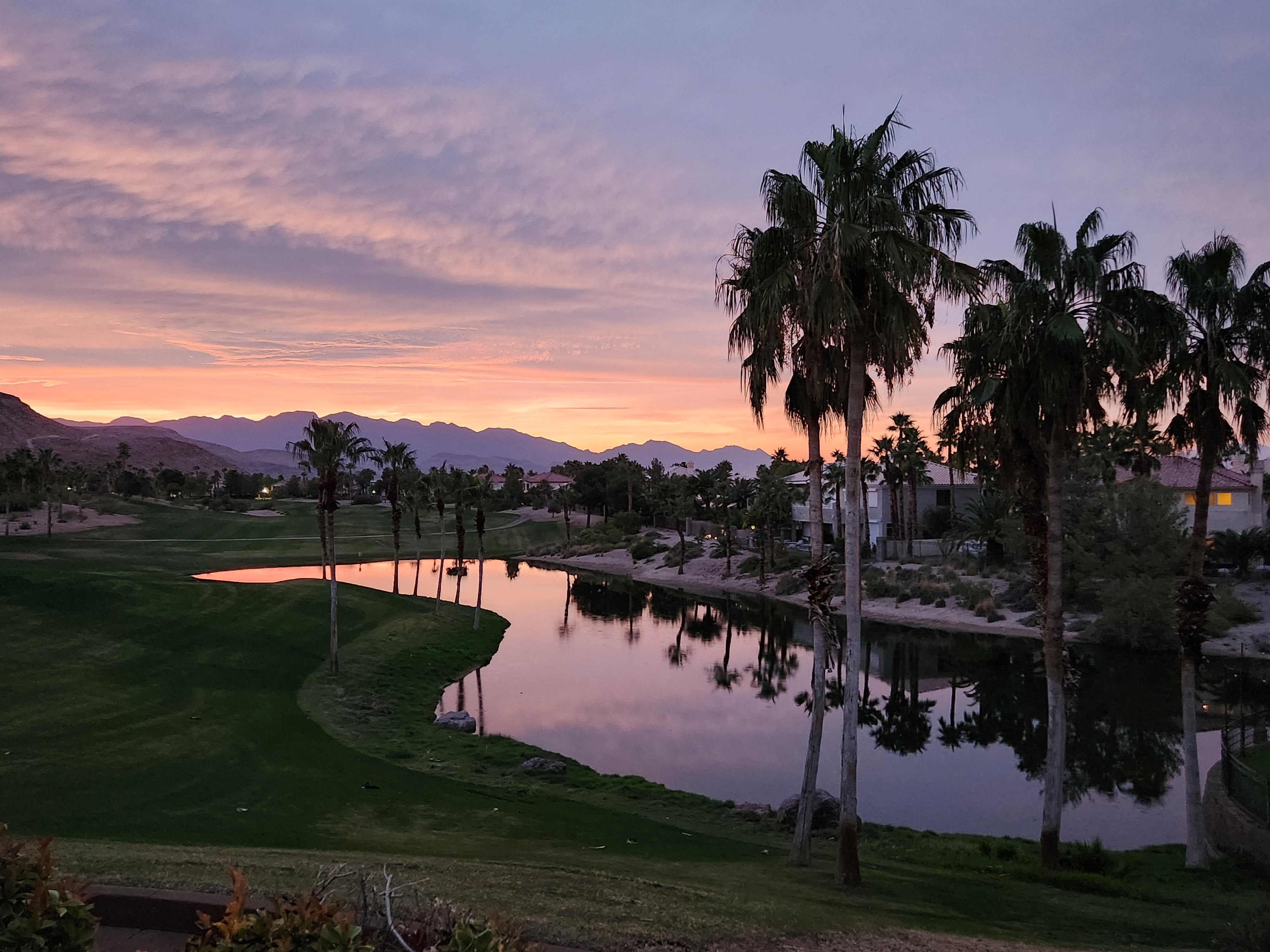 Sunset view over a golf course reflecting pond near Spanish Trail