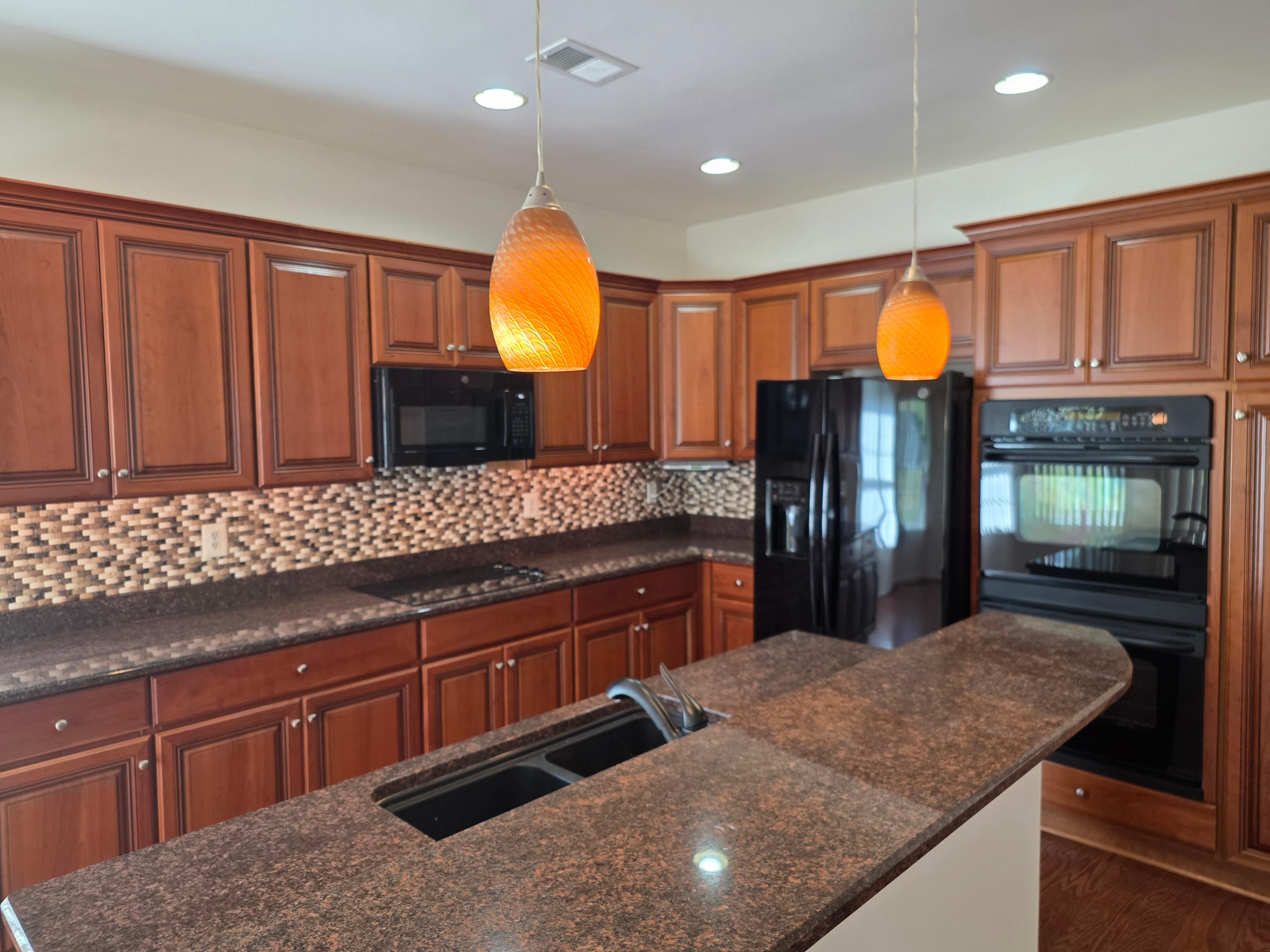 Kitchen with granite countertops and cherry wood cabinetry