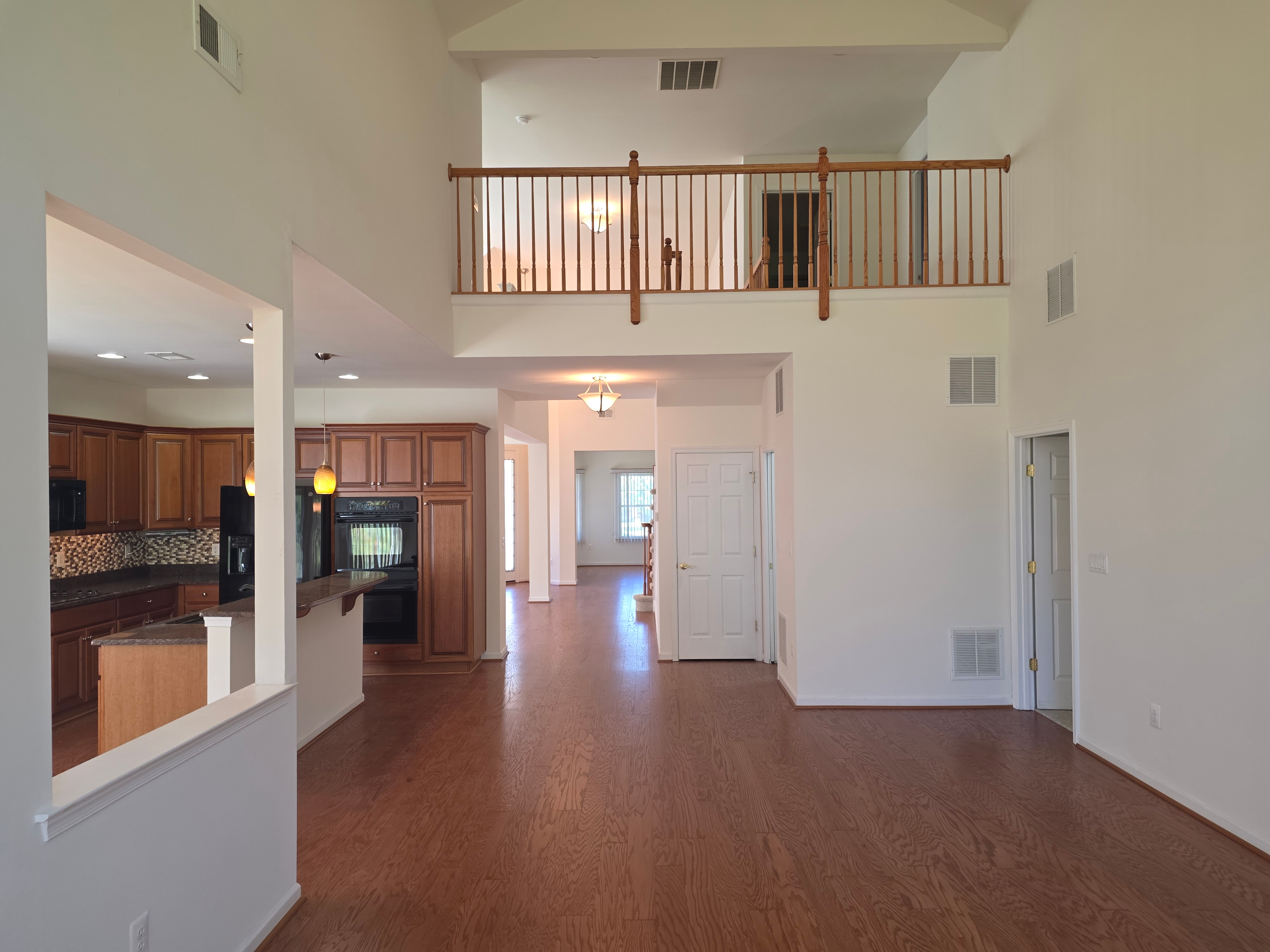 Open-concept living and dining with vaulted ceilings and loft