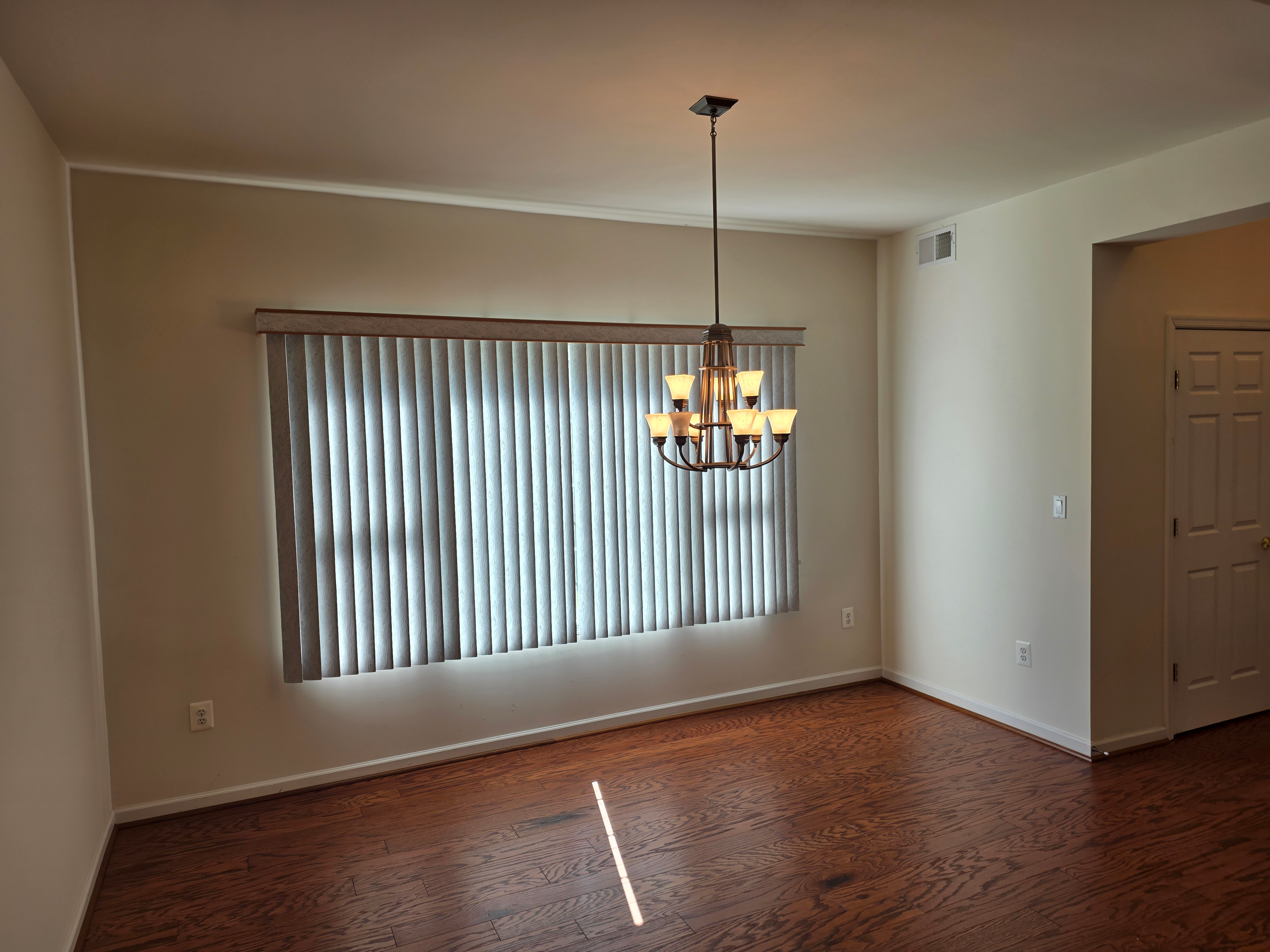 Dining room with hardwood flooring and natural light