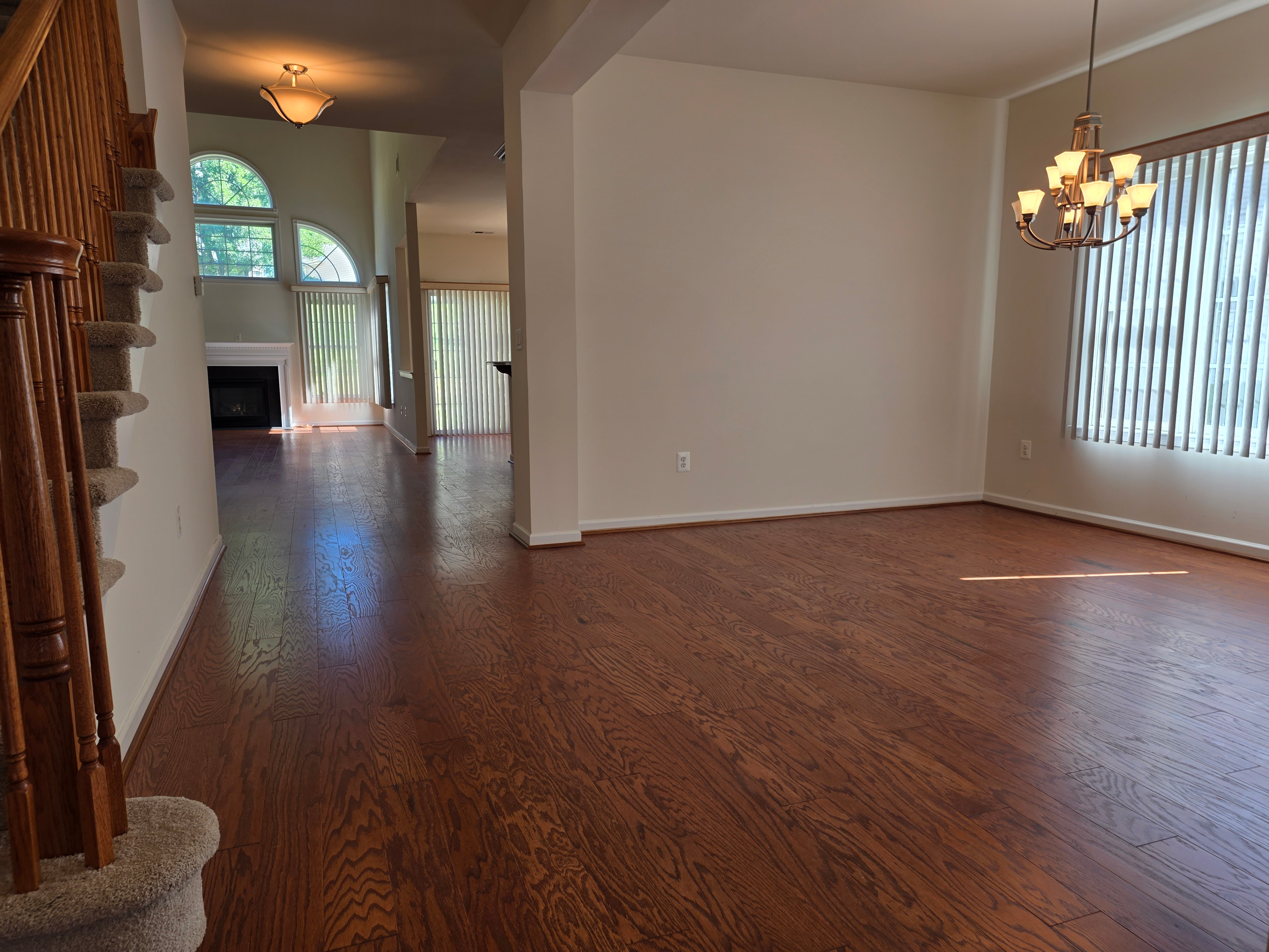 Dining area flowing into living room with arched windows