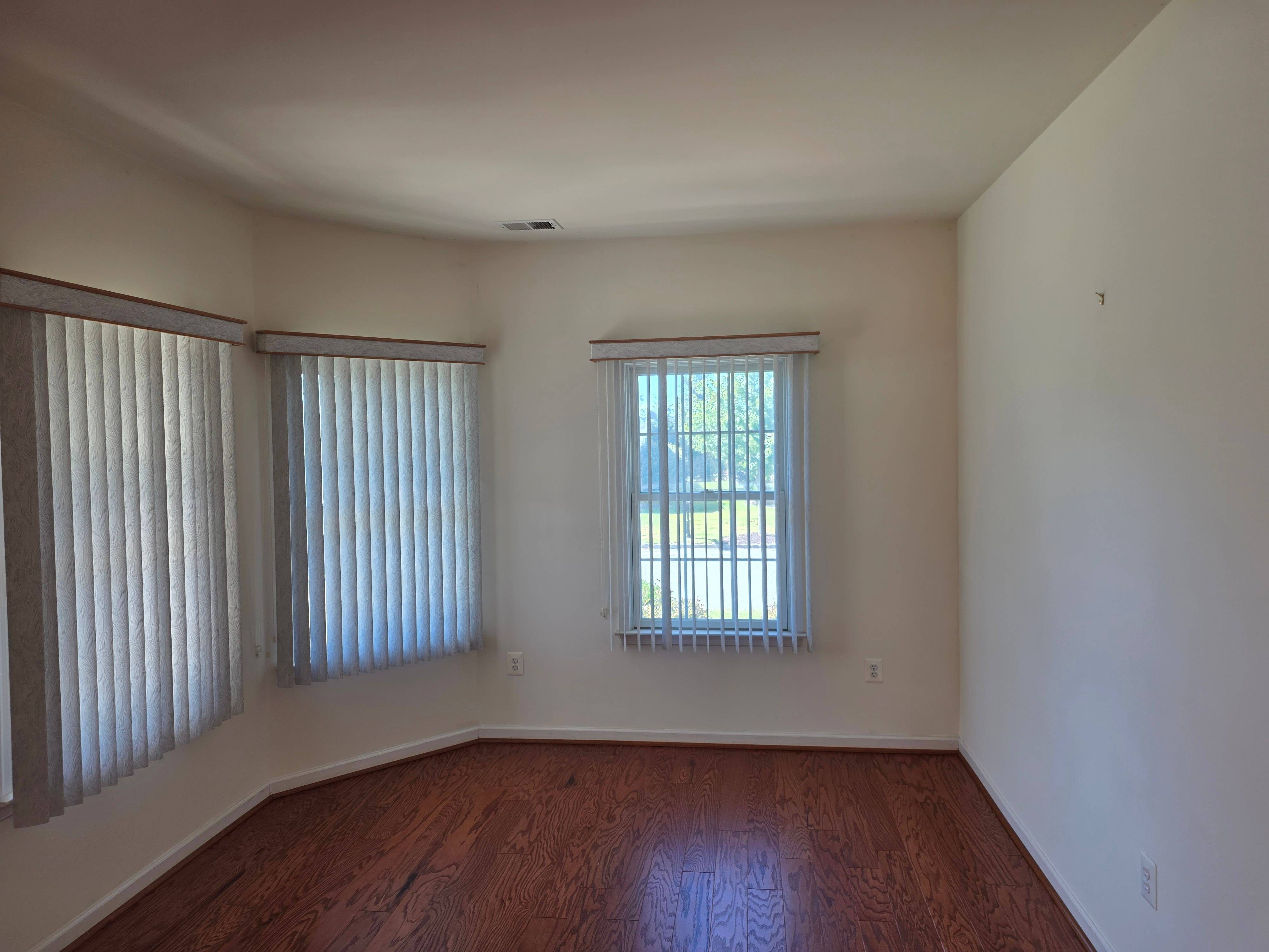 Living area with wood-look flooring and natural light