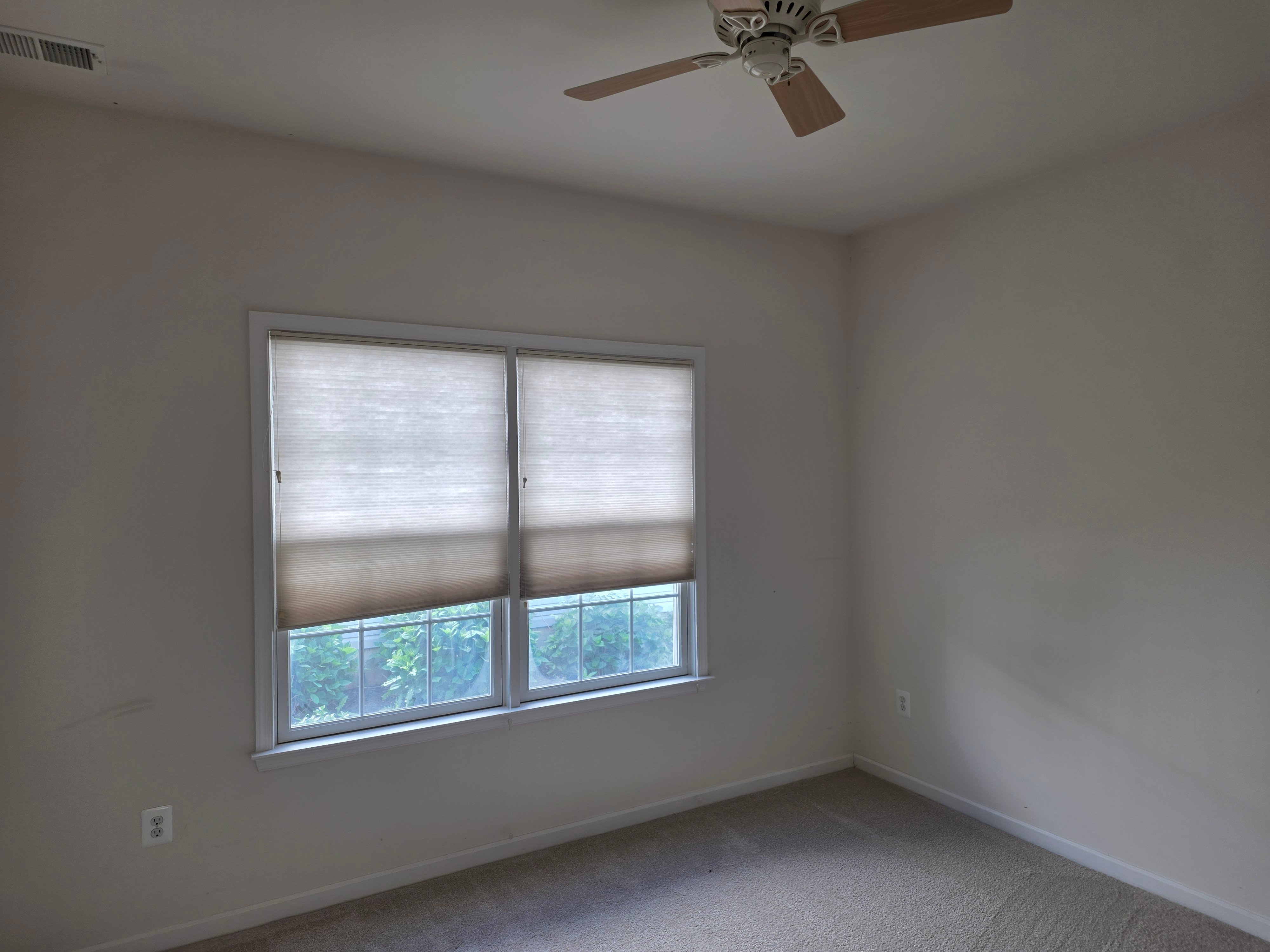 Secondary bedroom with carpet and neutral walls