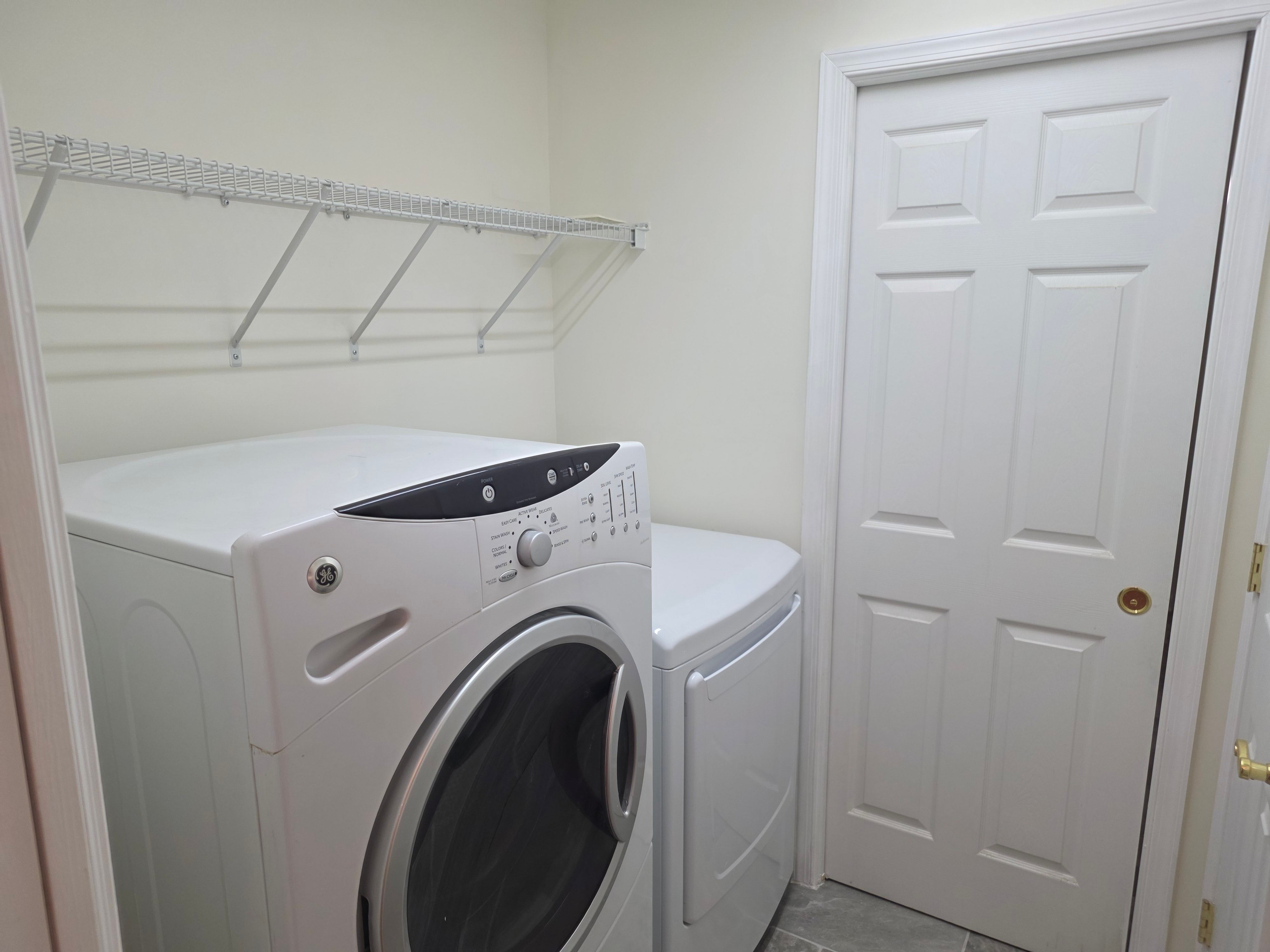 First-floor laundry room with washer and dryer