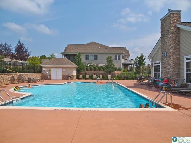 Community pool deck with lounge chairs