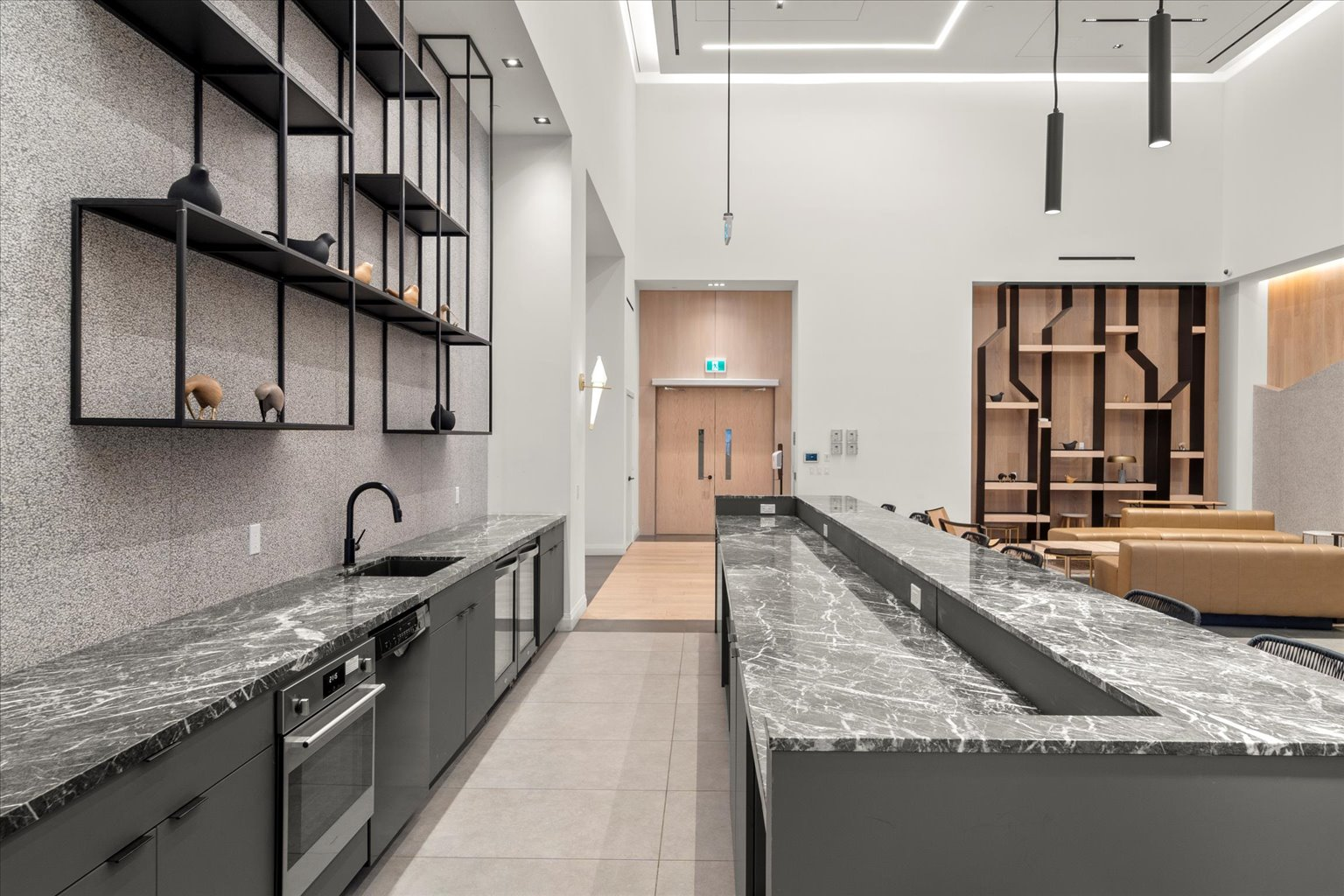 Lounge with marble countertops, stone walls, and pendant lighting