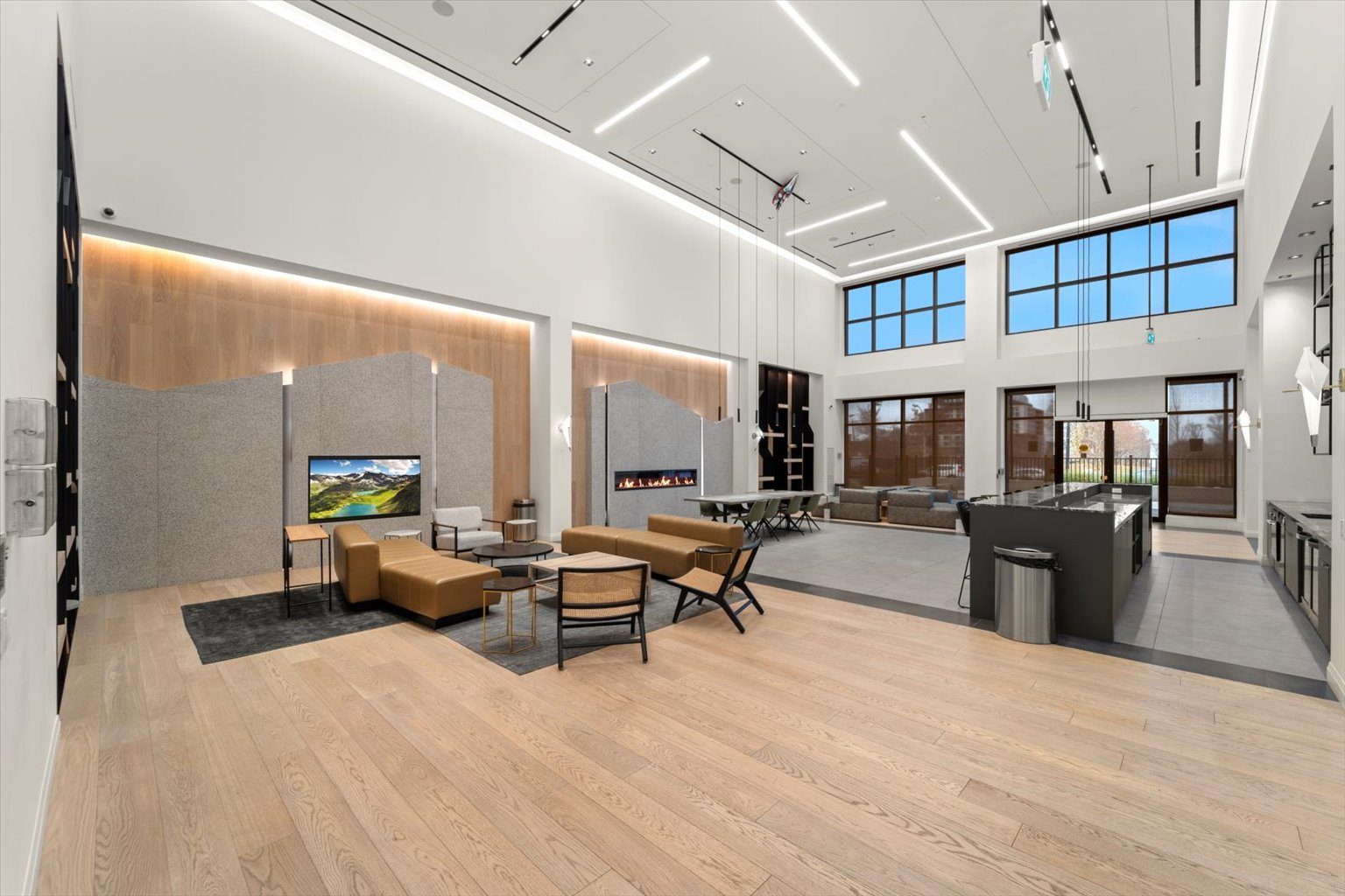 Lounge with leather couches, wood paneling, and linear lighting