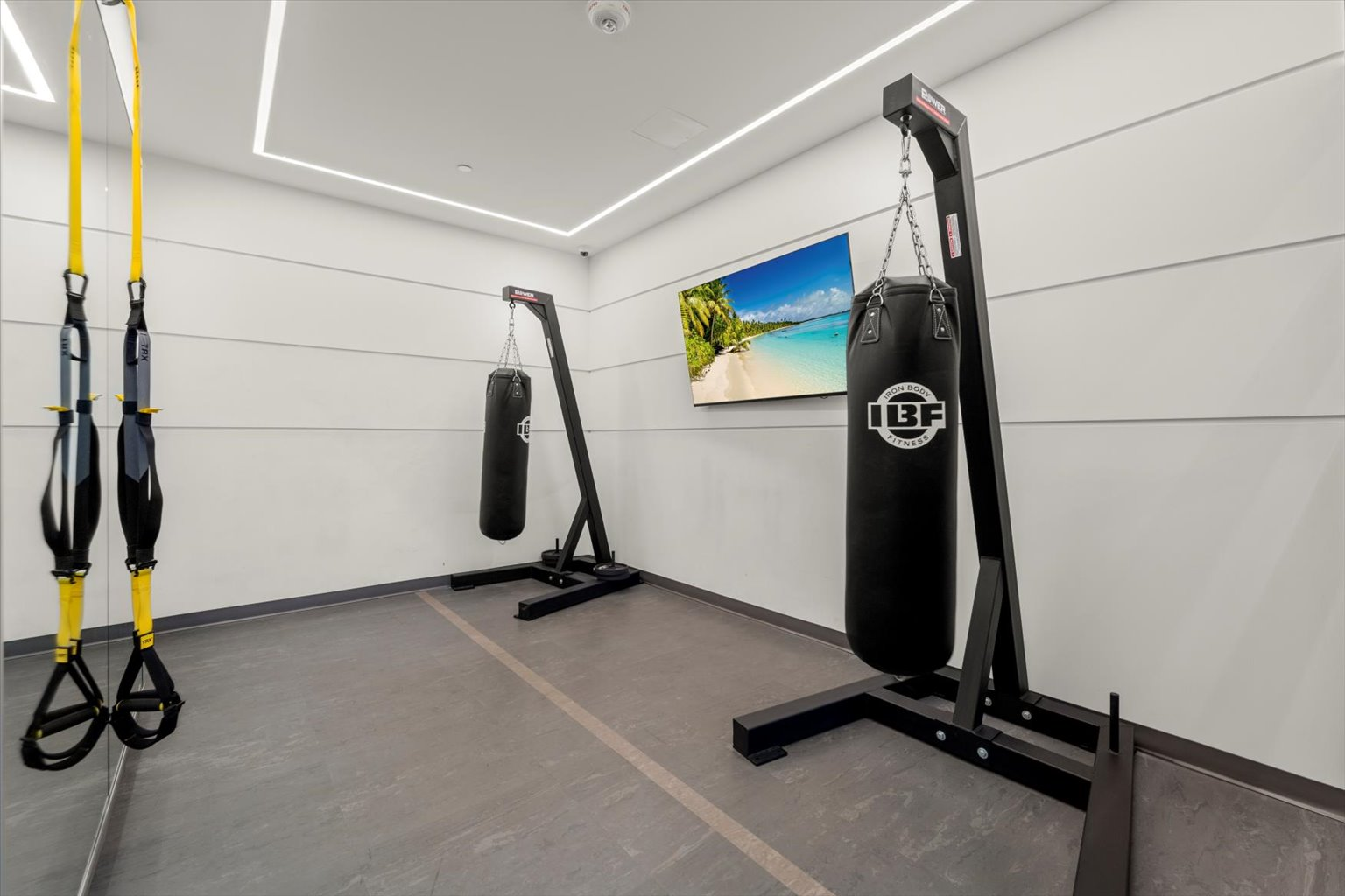 Boxing area with punching bags and suspension training straps