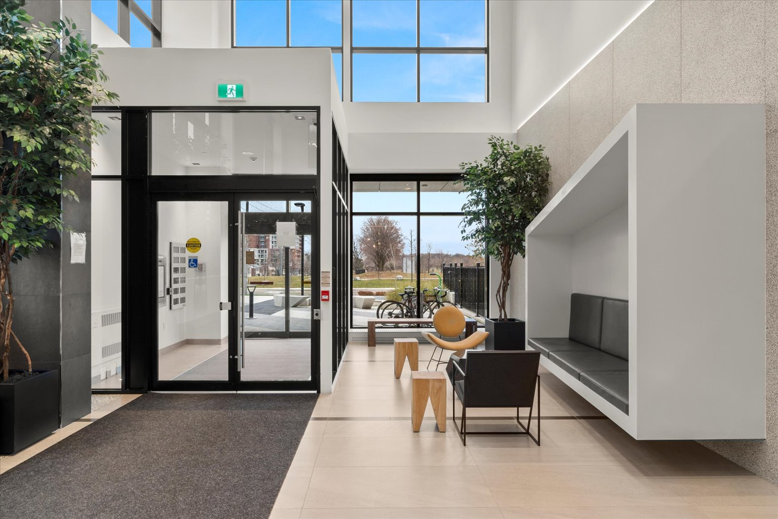 Lobby entrance with vaulted ceilings and floor-to-ceiling glass