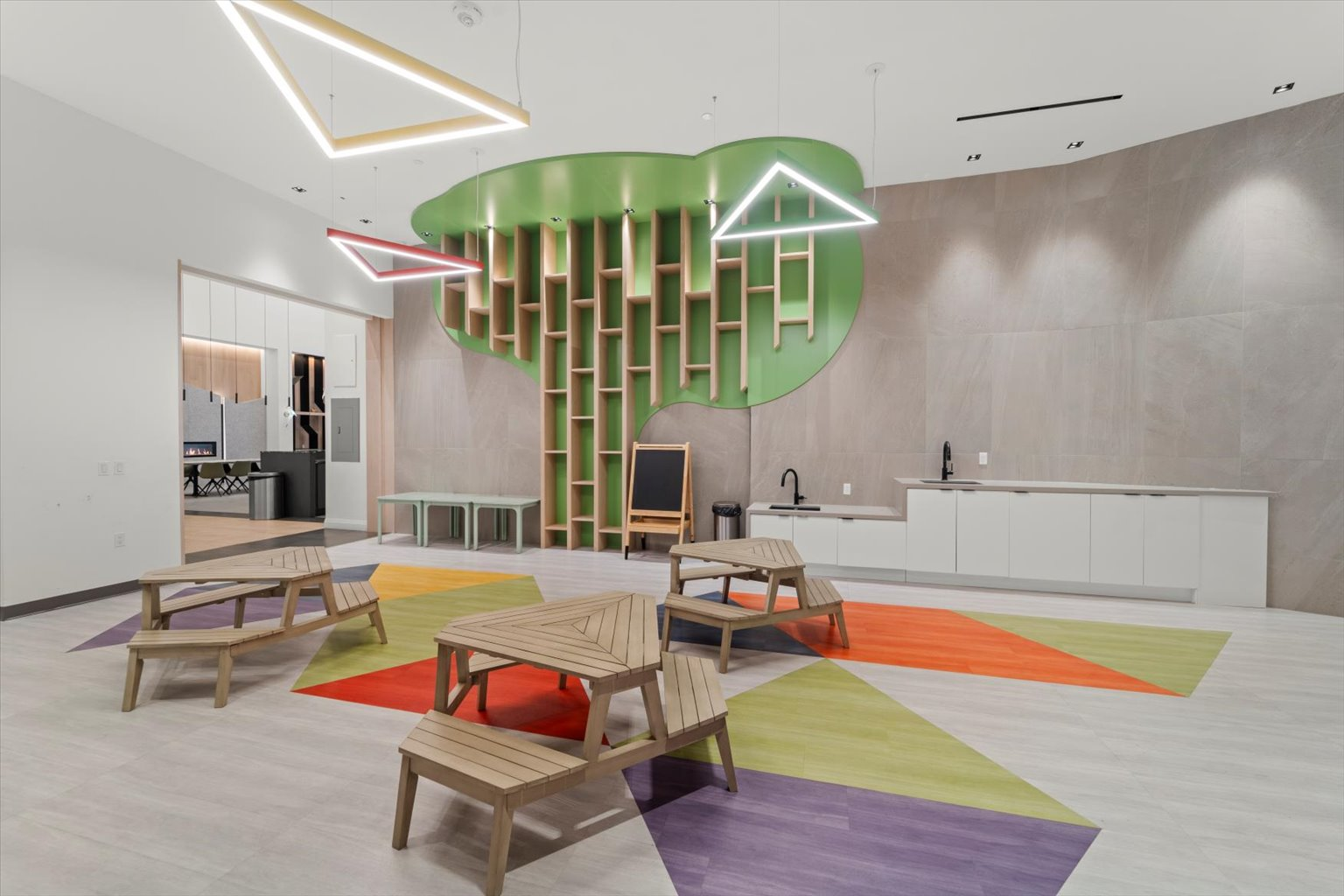 Kids play room with activity tables and chalkboard