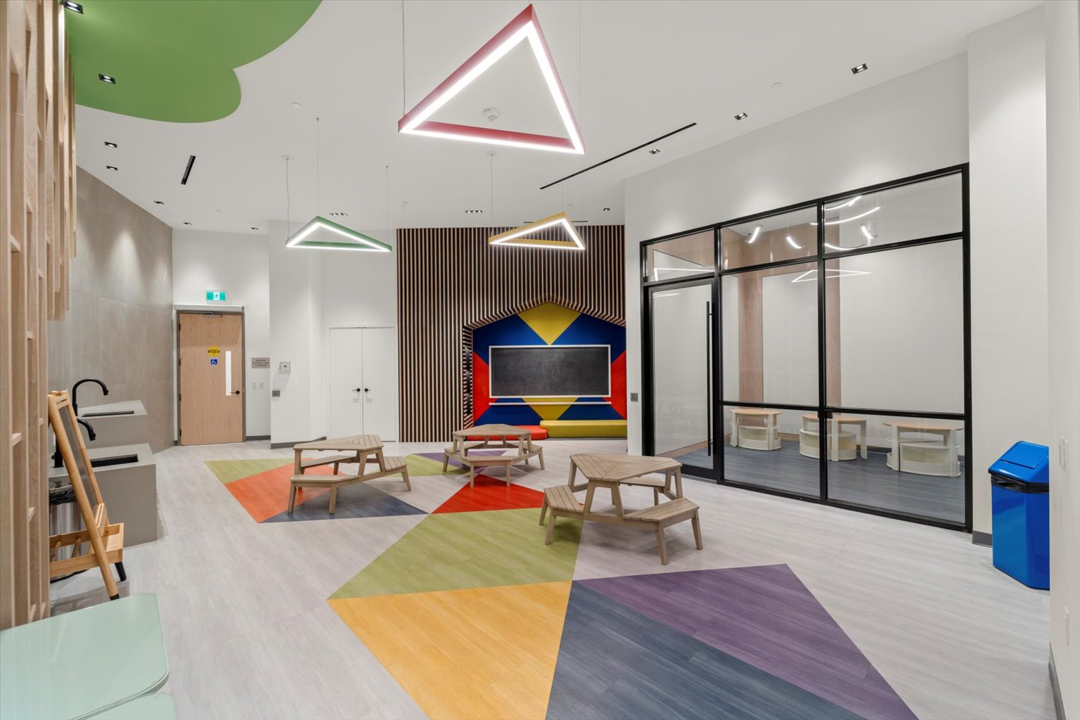 Kids play room with wood slat detailing and glass partitions