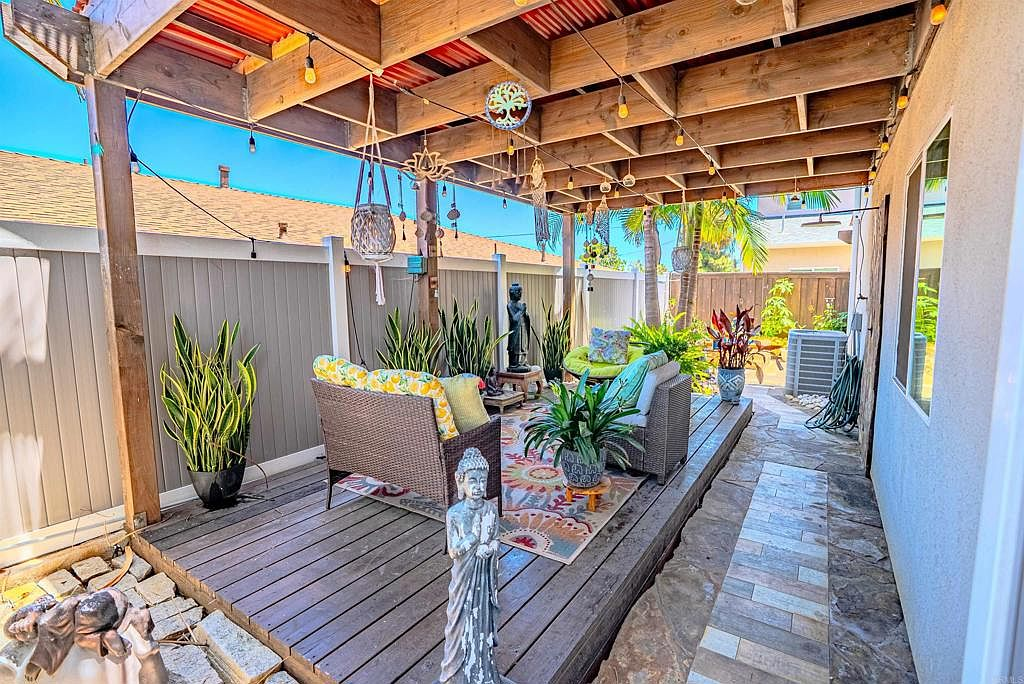Pergola-covered deck with wood beam structure and string lights