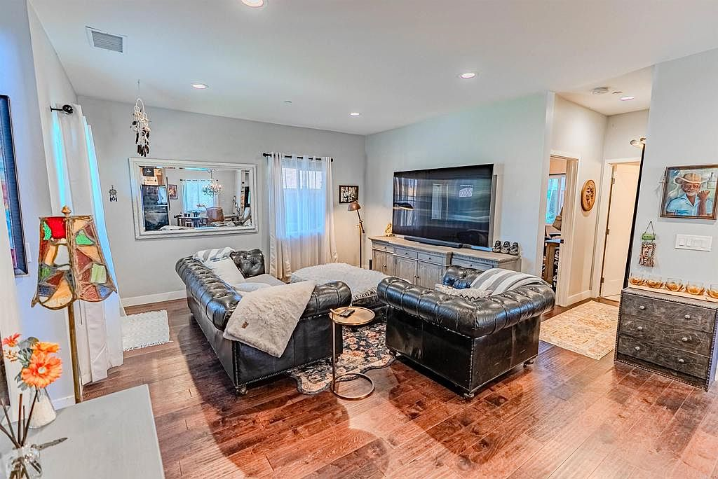 Living room with dark hardwood floors and modern furnishings