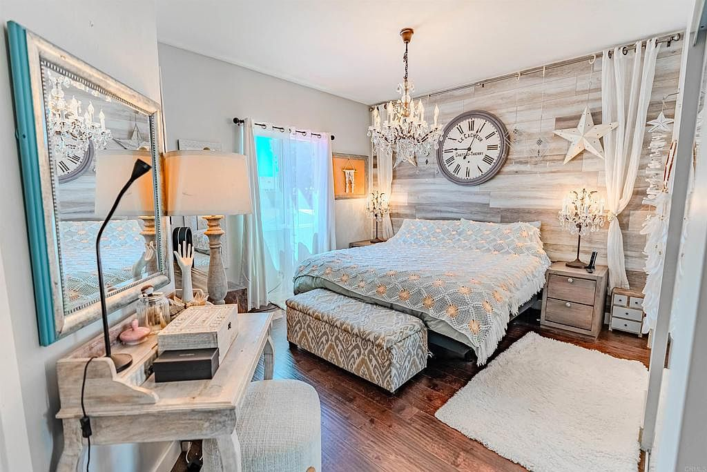Primary bedroom with rustic wood accent wall and coastal decor