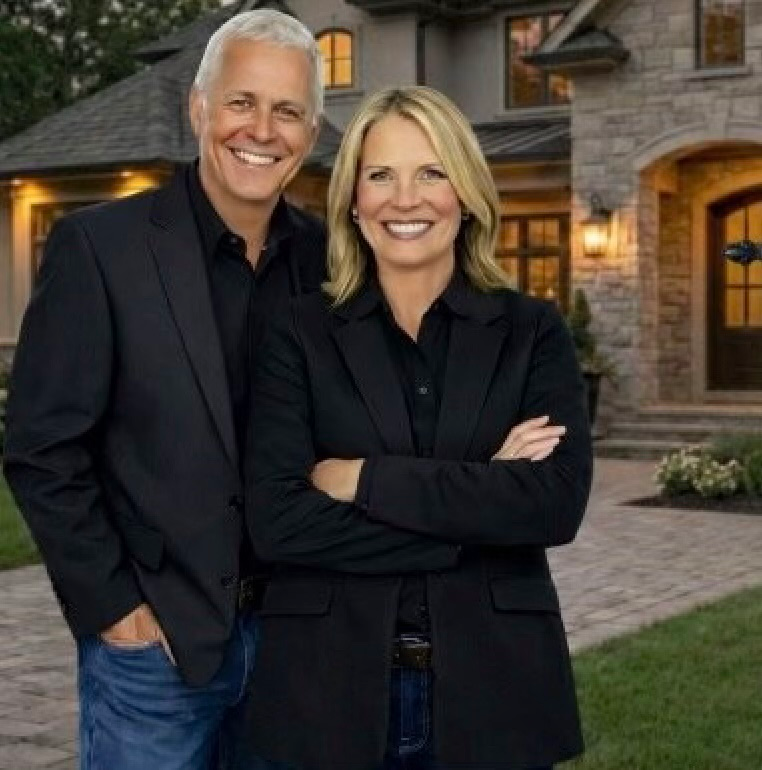 Mike Battistelli and Janet Tate in front of a luxury estate