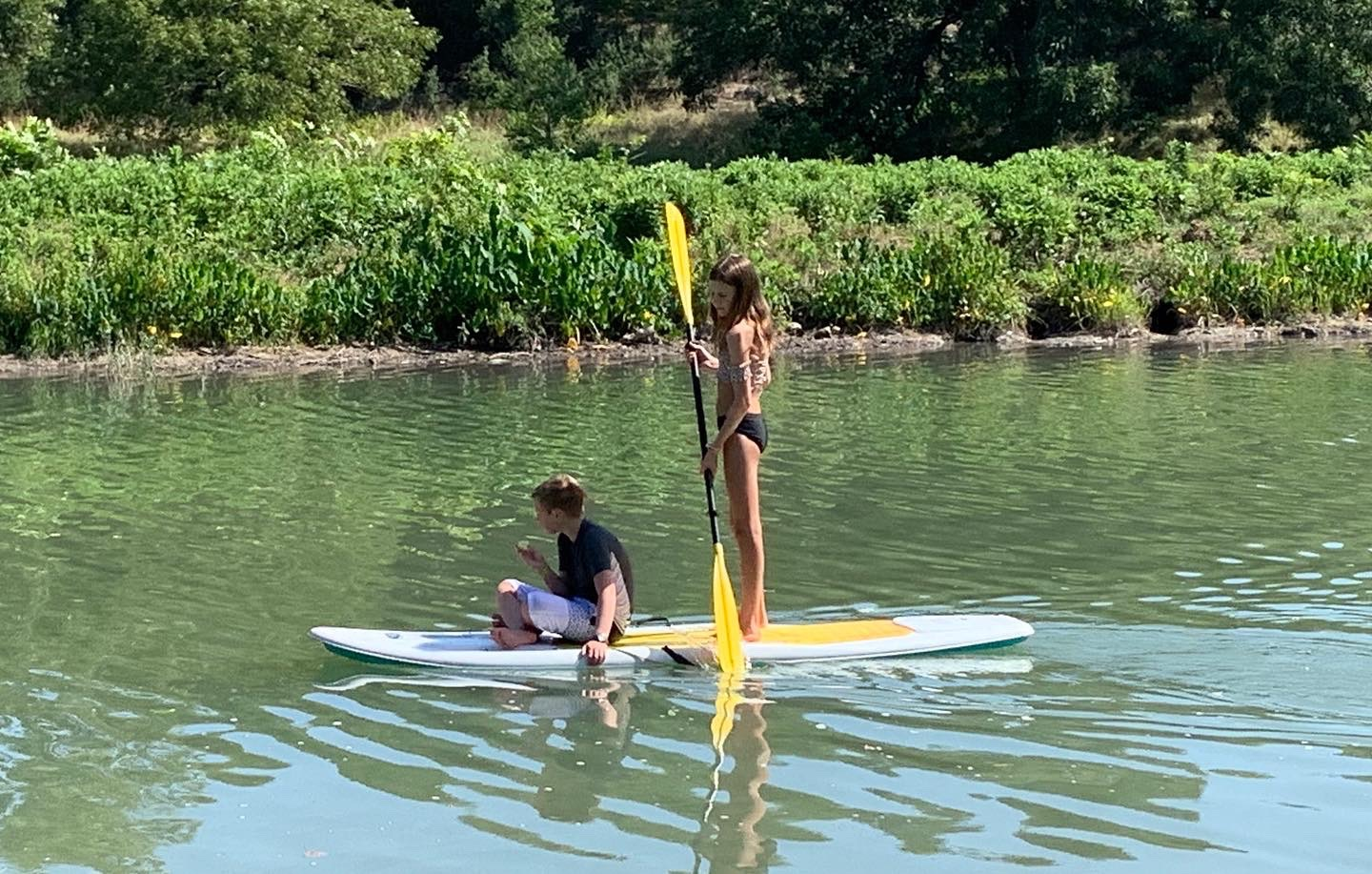 Swimming area at Cypress Creek (Seasonal) — clear water surrounded by Hill Country cypress trees and limestone