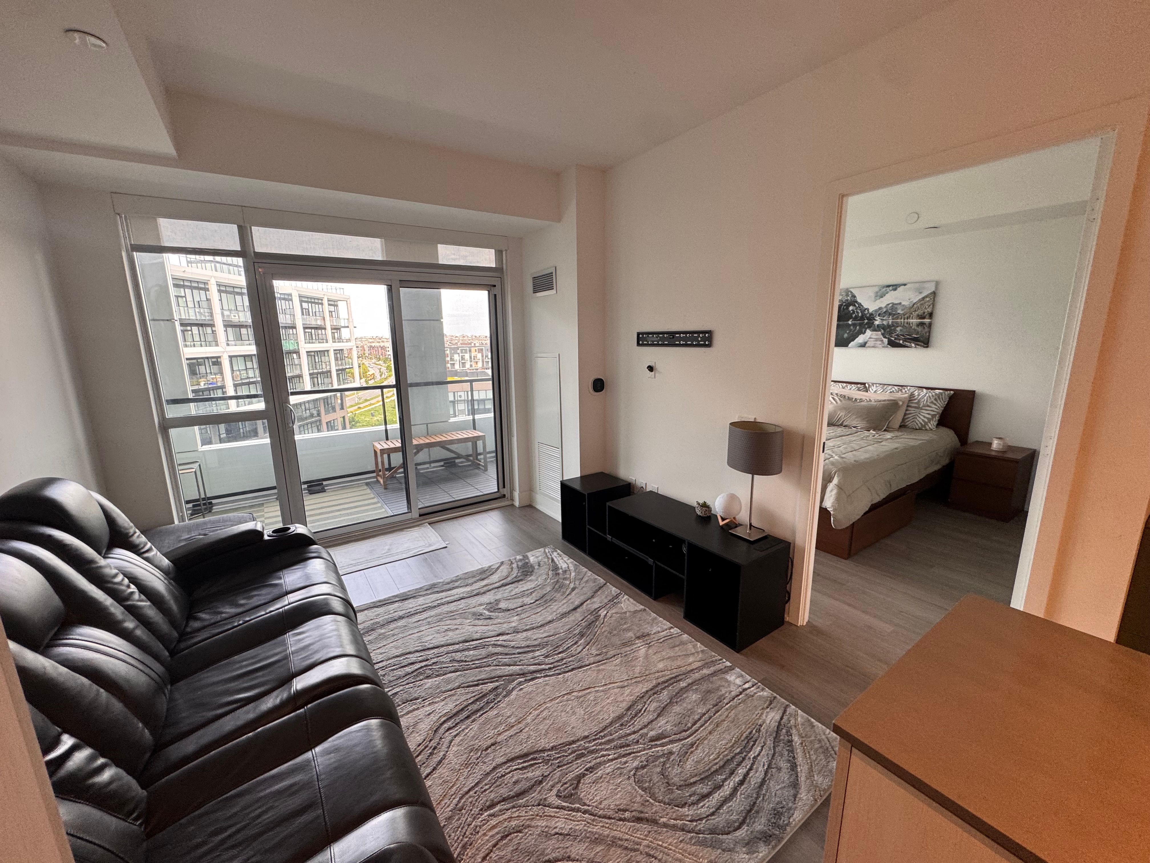 Virtually staged living room with floor-to-ceiling windows and balcony view