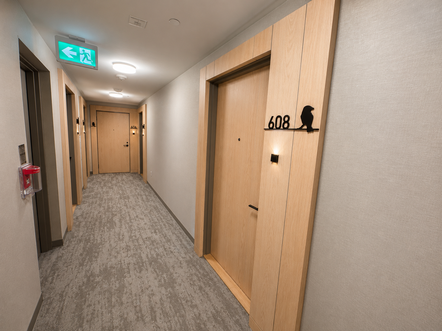 Common hallway entrance to Unit 608 with wood door frames and grey carpet