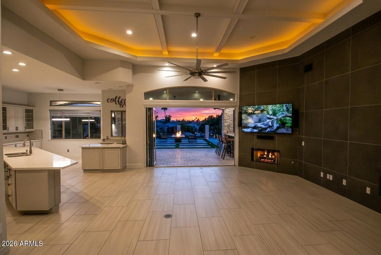 Expansive open-concept living, dining, and kitchen area with warm evening lighting