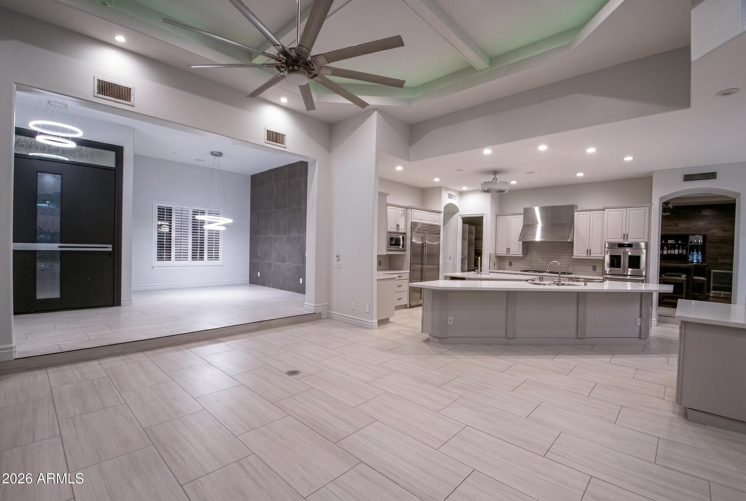 Open-concept living and kitchen area with recessed cove lighting