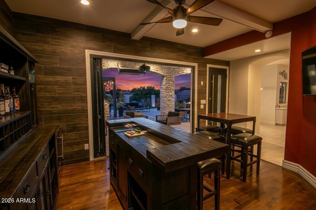 Indoor bar and entertainment room with dark wood accents