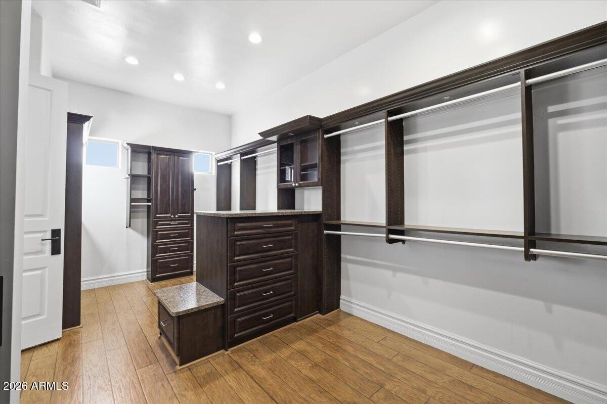 Custom walk-in closet with dark espresso cabinetry and built-in shelving