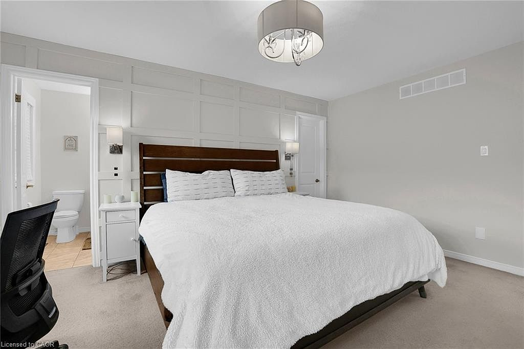 Primary bedroom with wainscoting accent wall