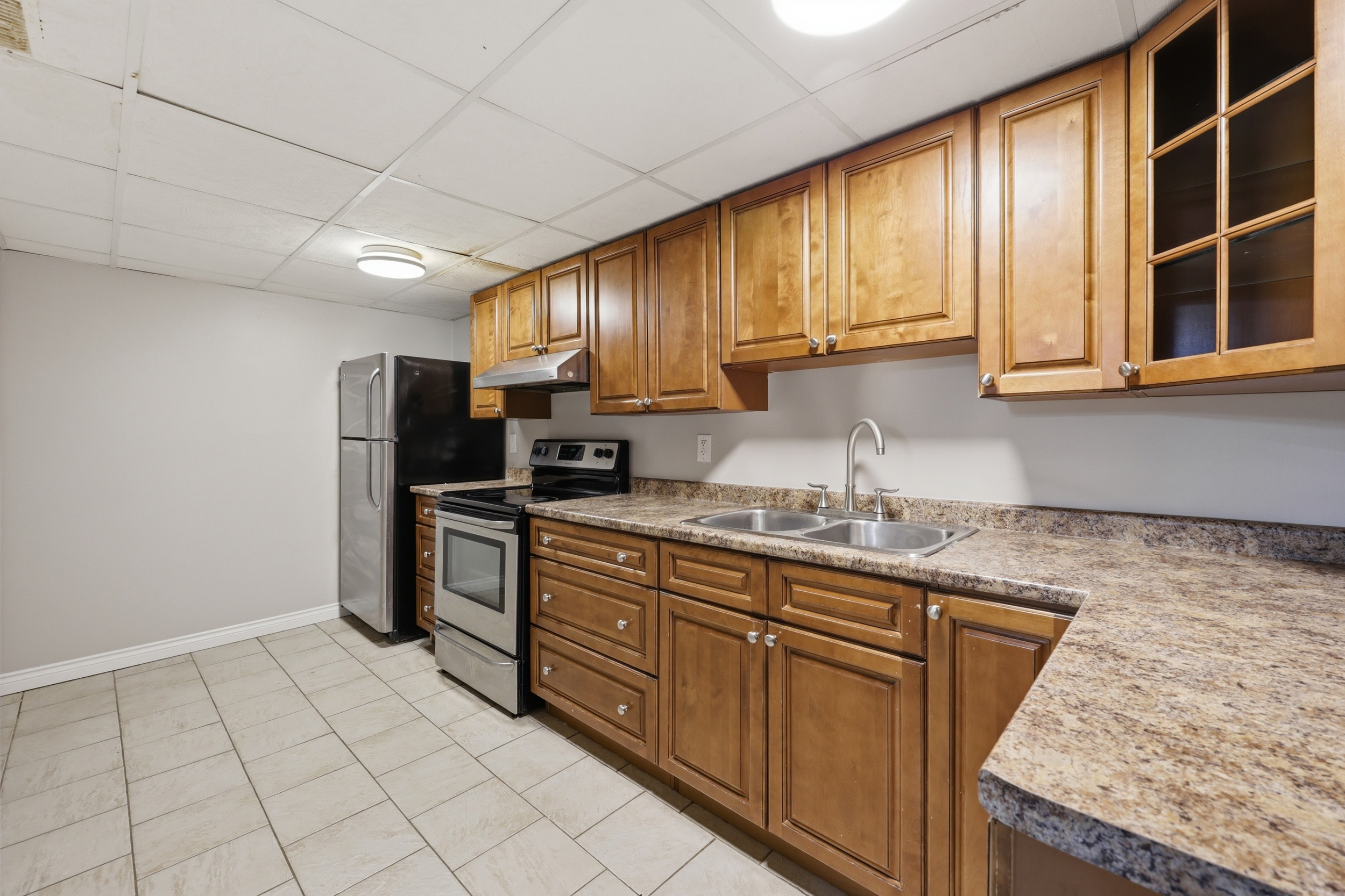 Lower level kitchen with galley layout and stainless appliances
