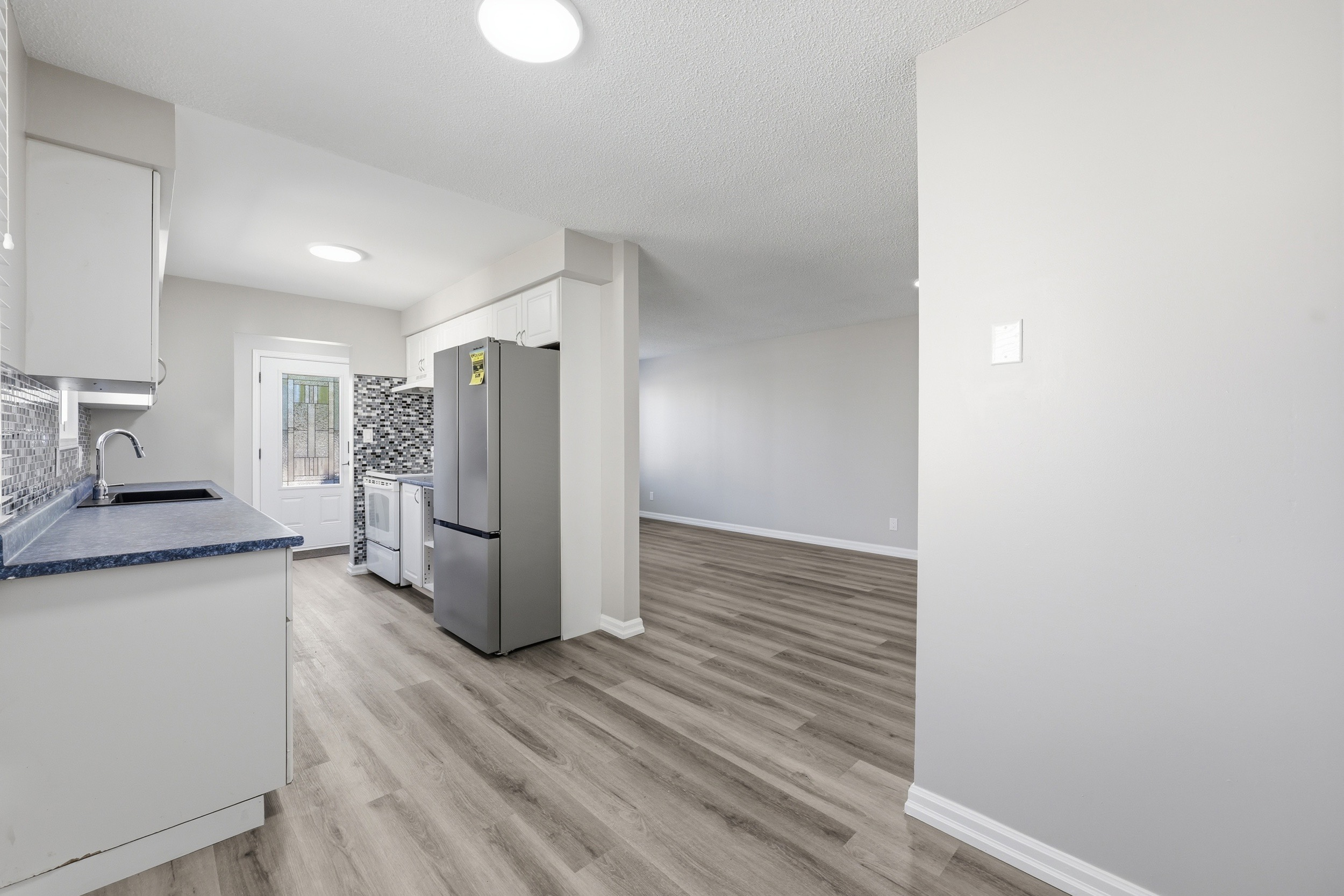 Kitchen view connecting to main living area