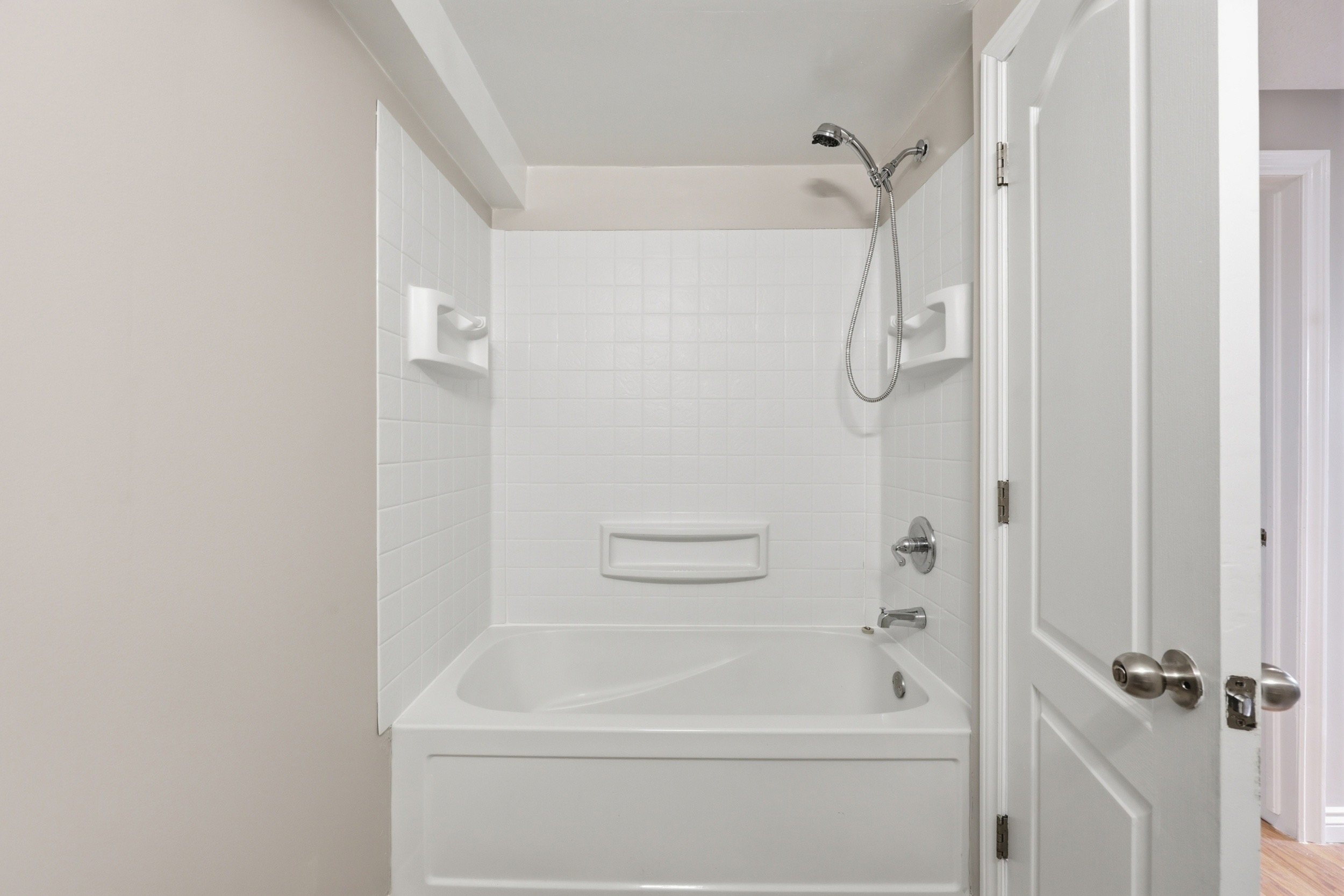 Updated bathroom with white subway tile tub surround