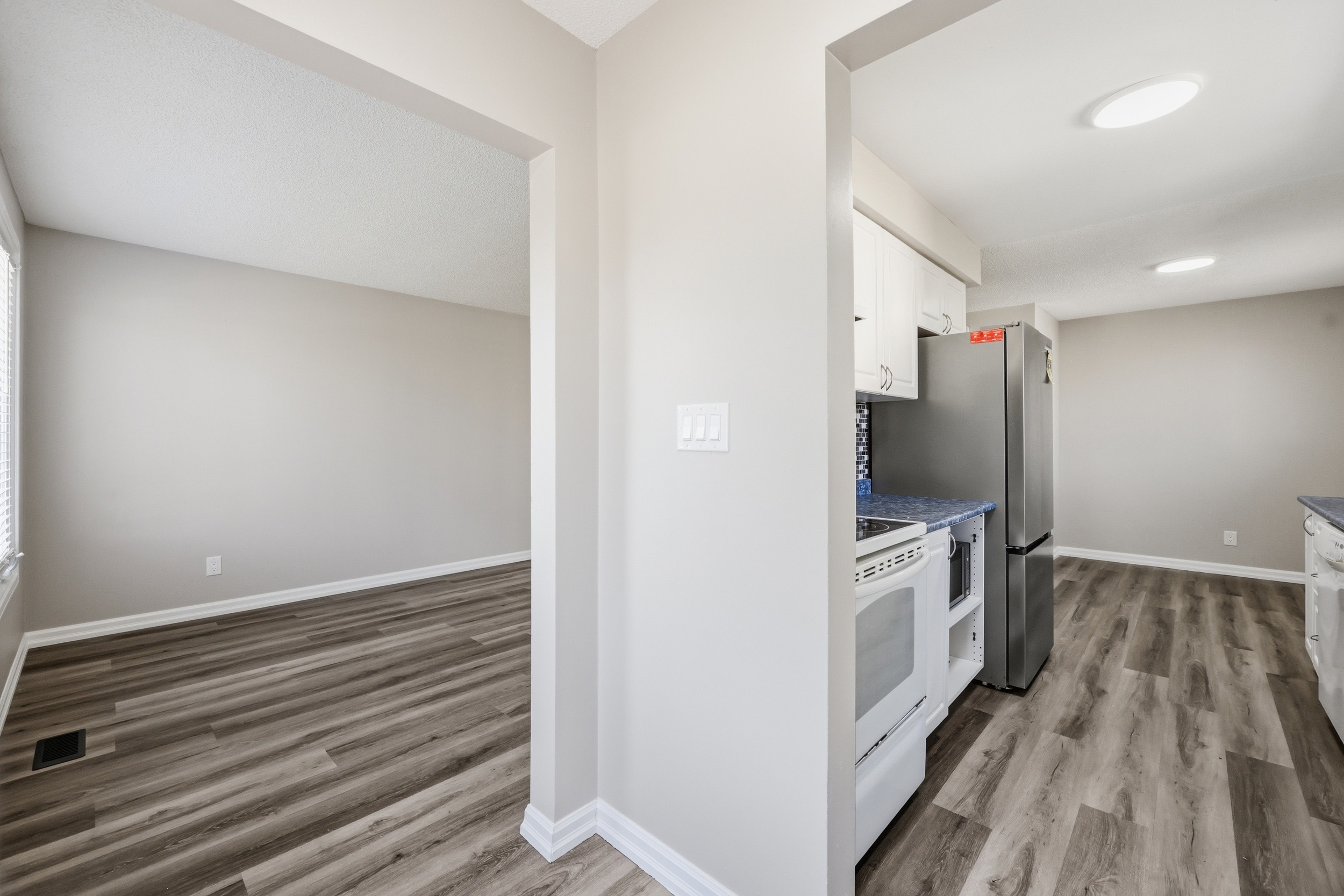 Kitchen view from living area showing appliances