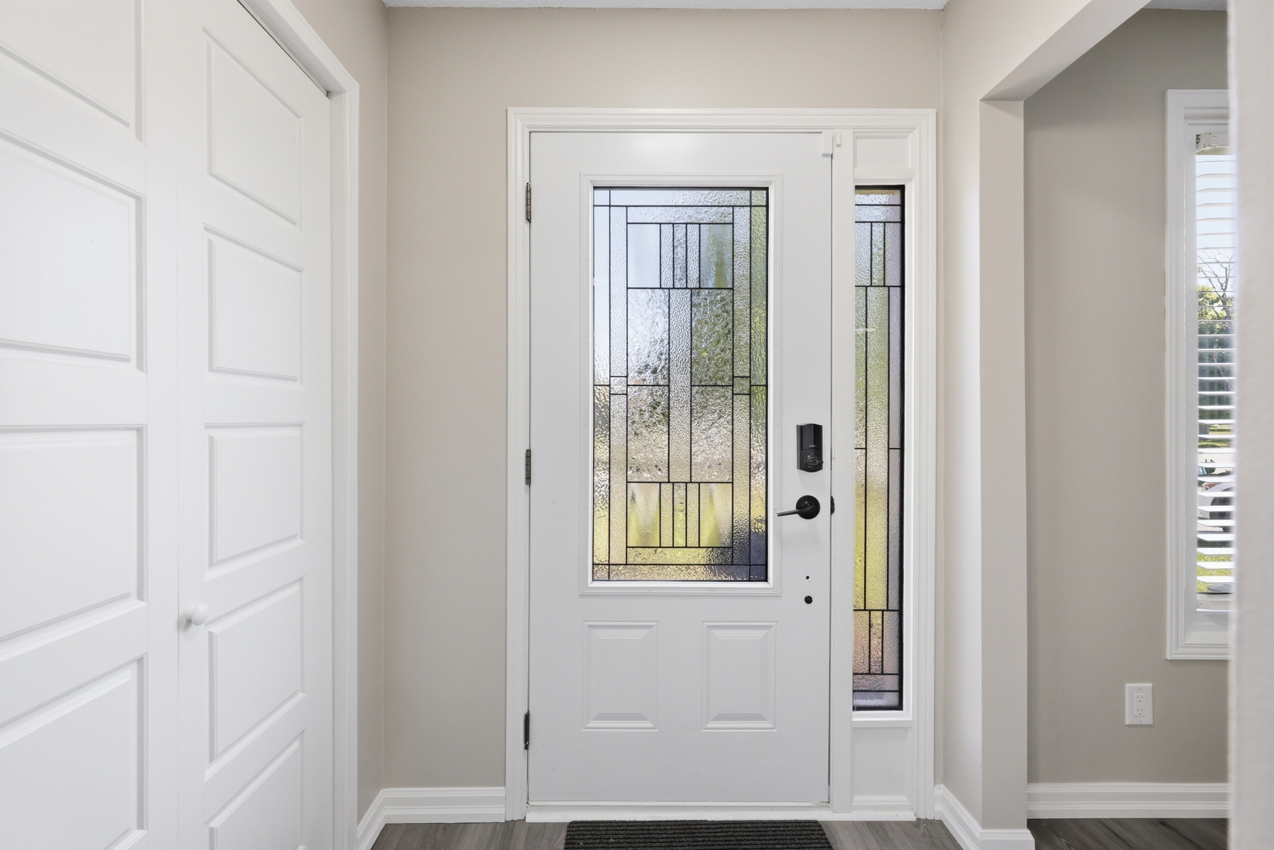 Front entryway with geometric leaded glass door