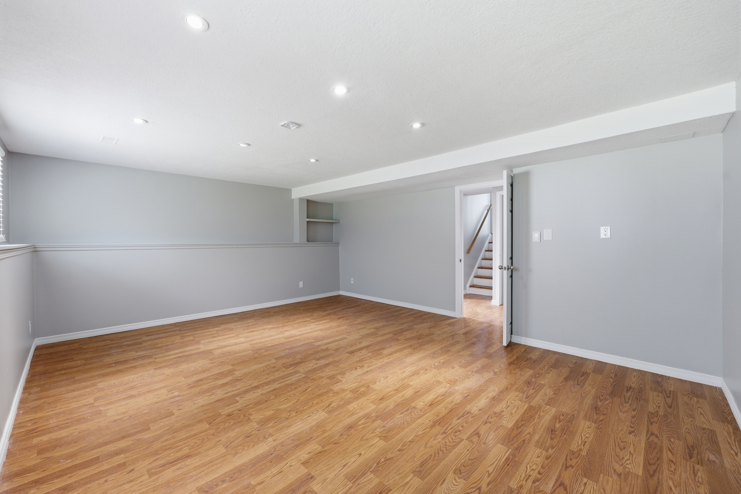 Vacant living area with recessed lighting