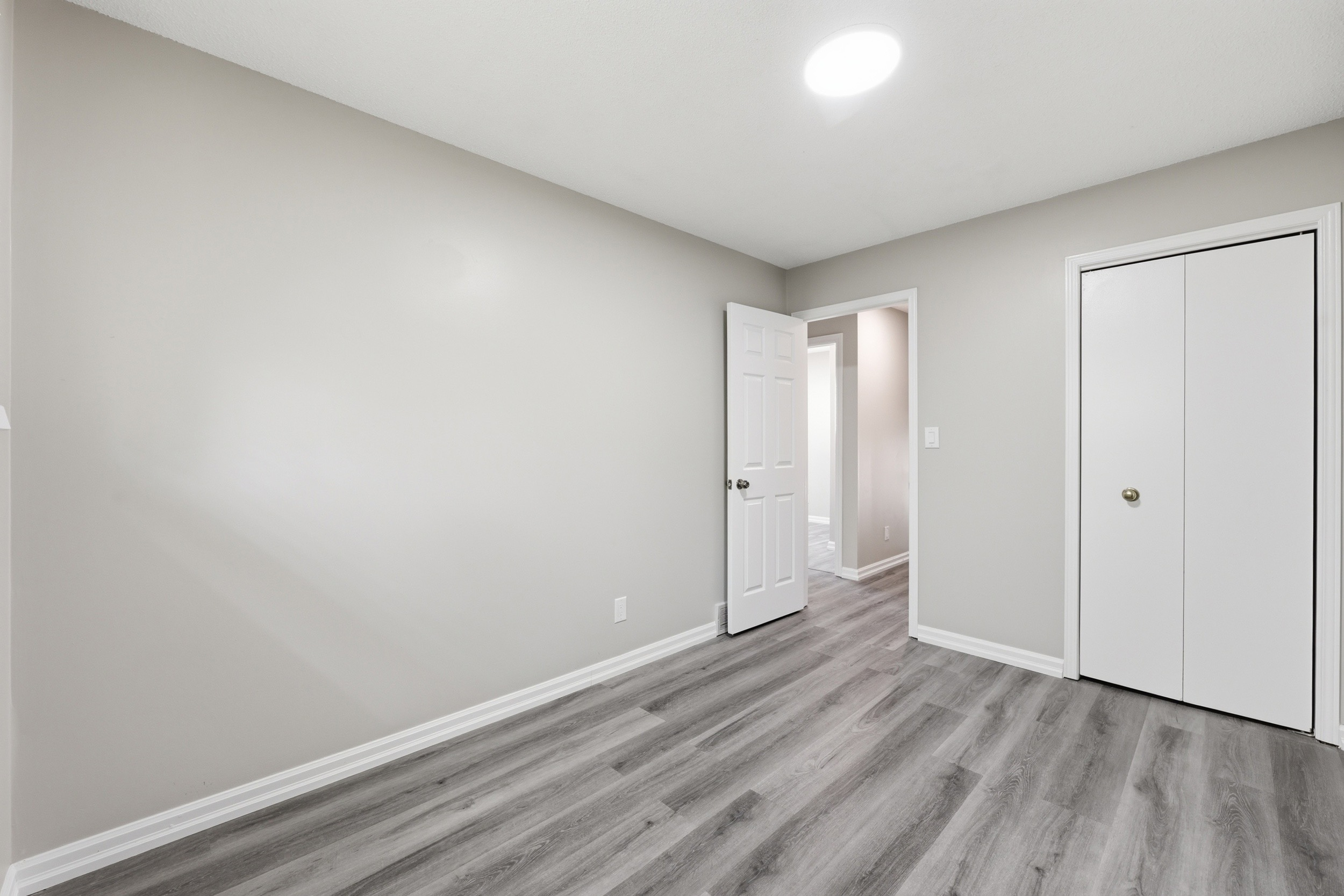 Empty bedroom with new laminate flooring