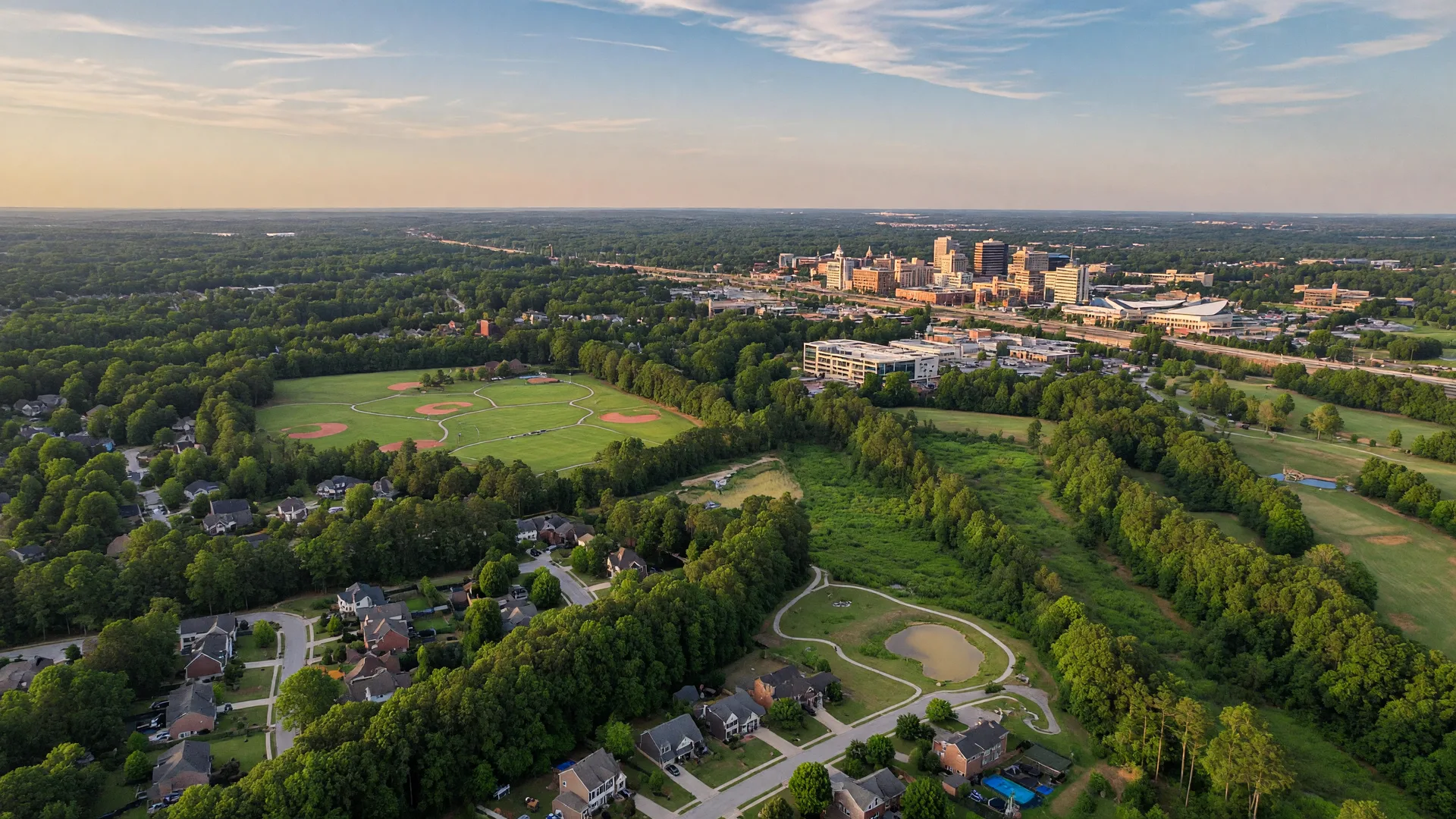 Aerial view of Cary North Carolina suburban landscape with tree canopy and parks