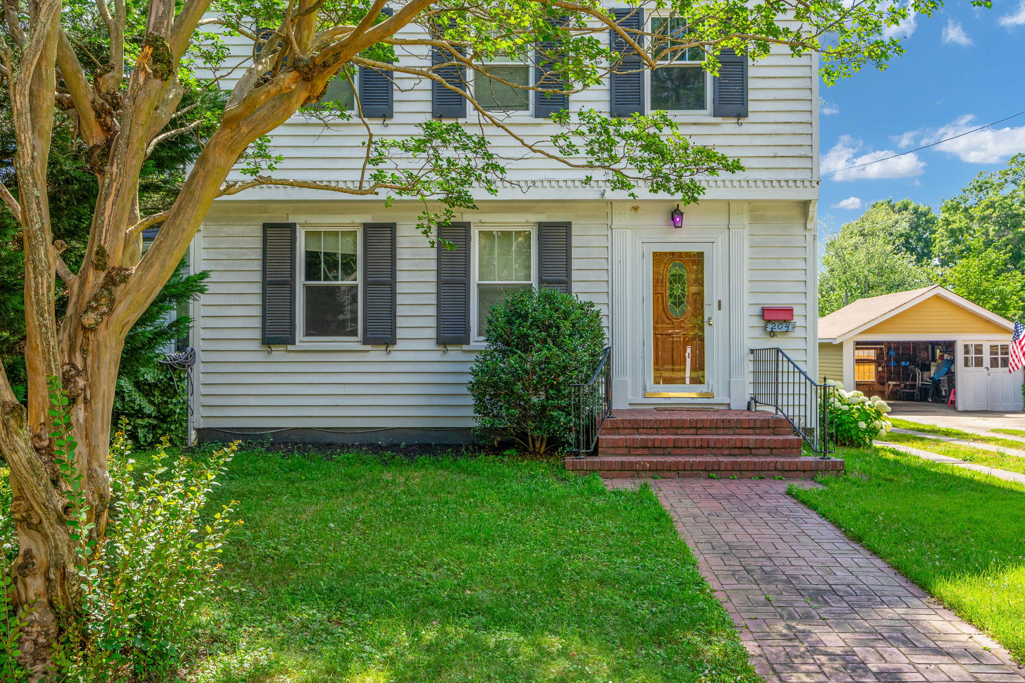 Front facade eye-level with vinyl siding and shutters