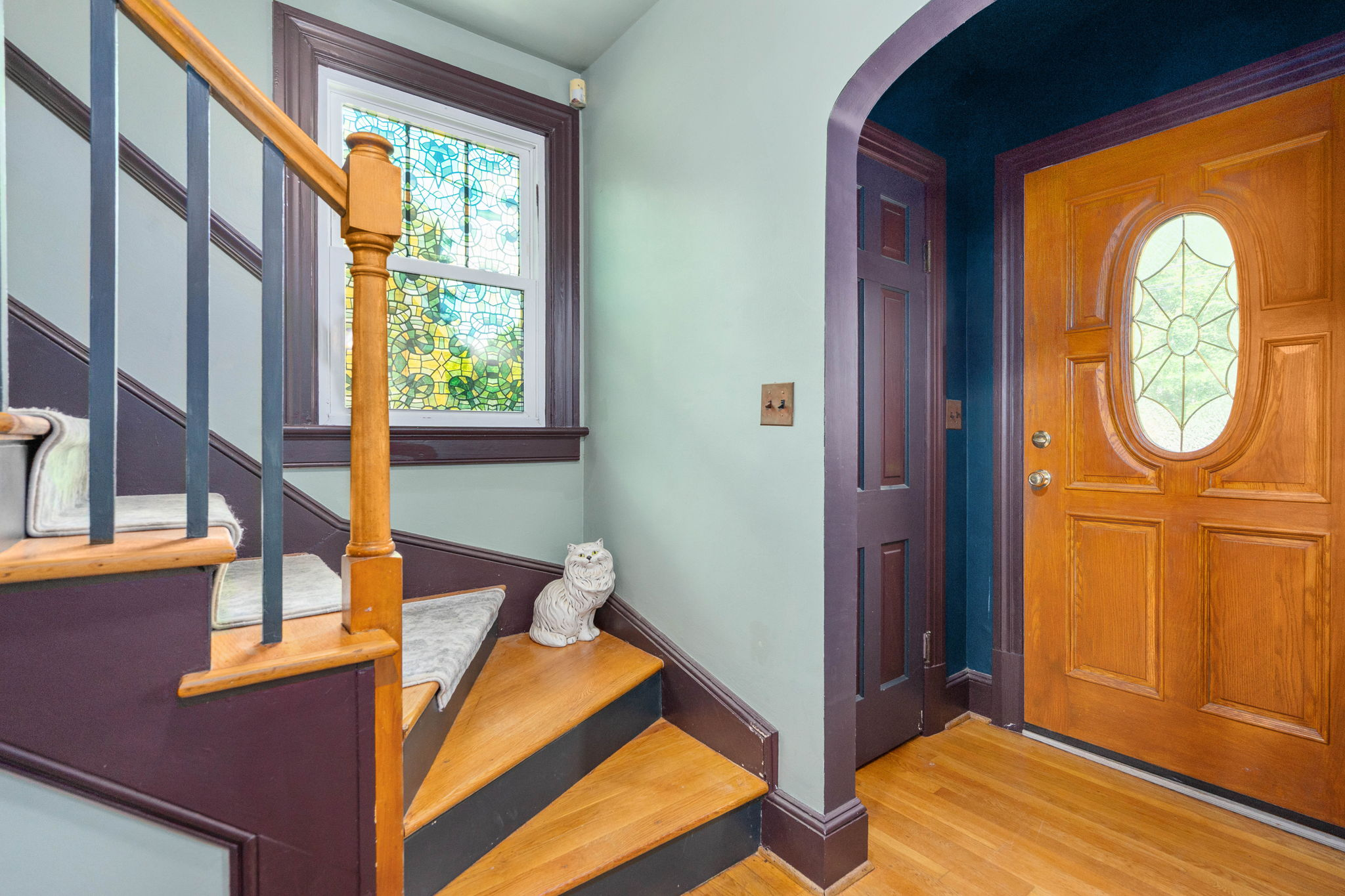 Foyer with staircase and arched doorway