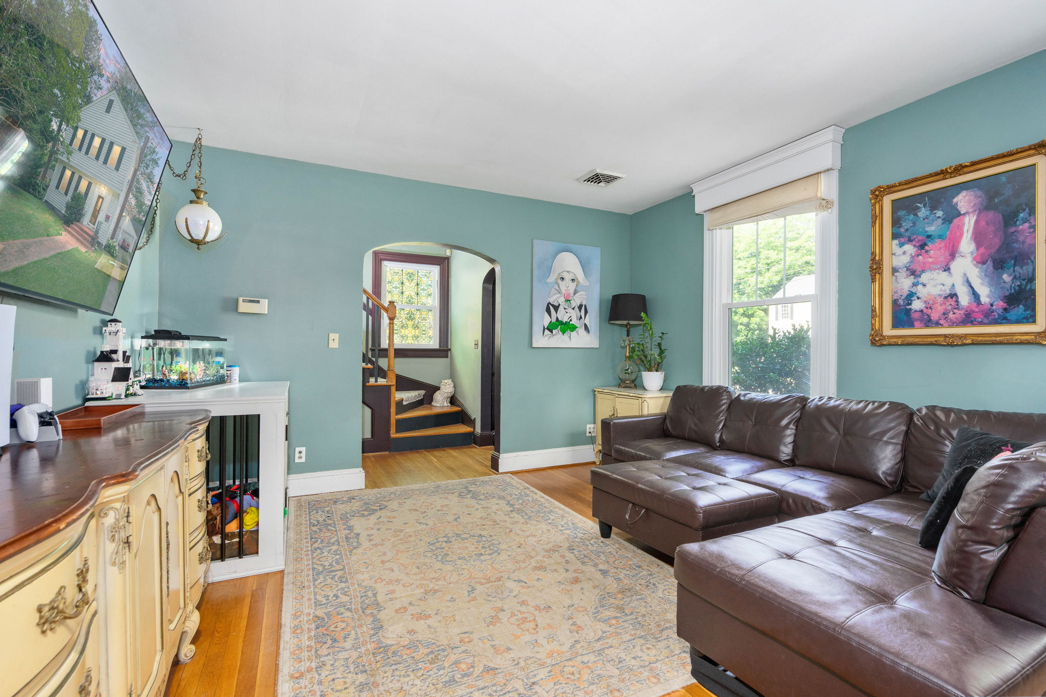 Living room with refinished hardwood floors and arched doorway