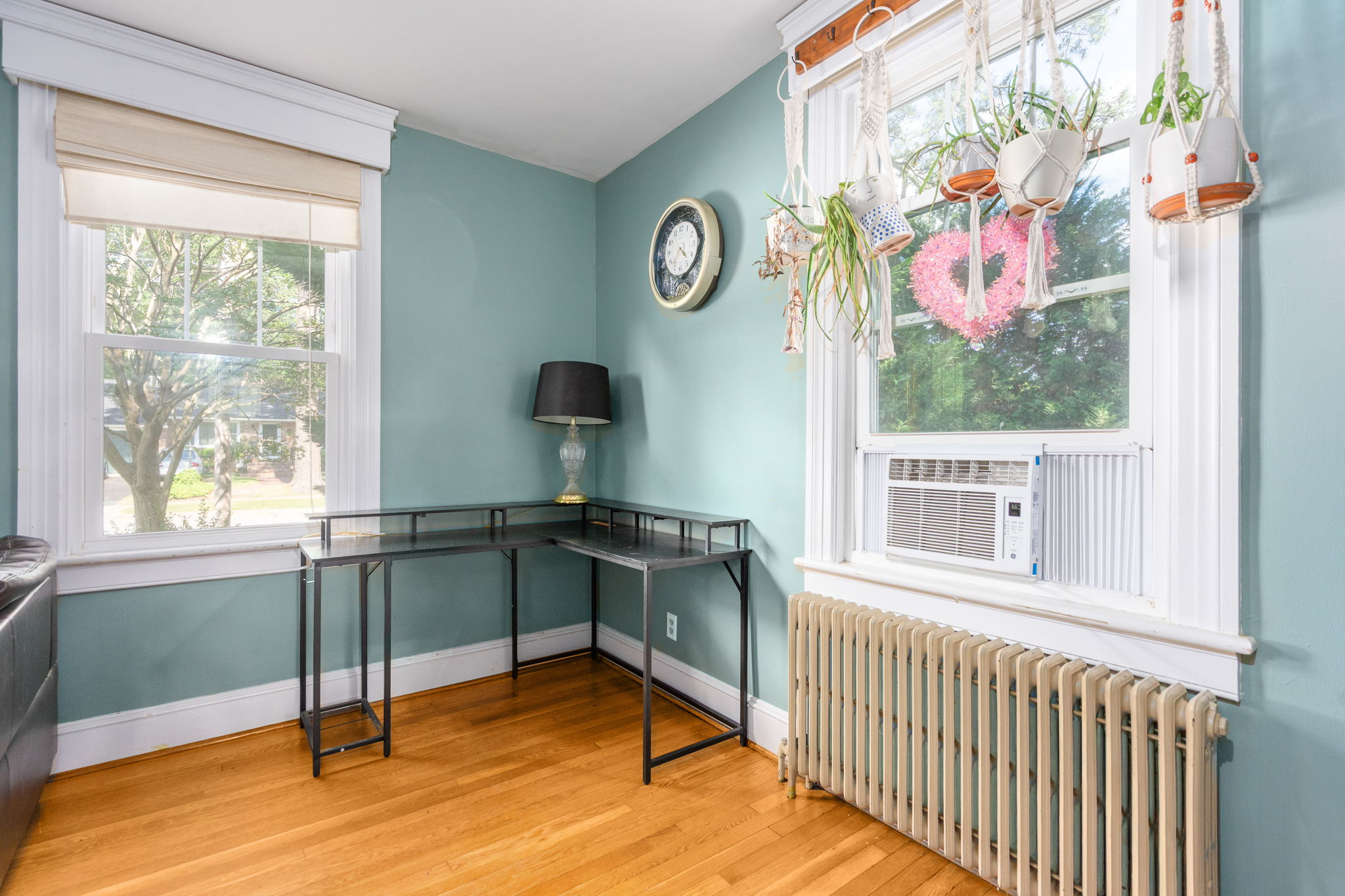 Bedroom or flex room with refinished hardwood floors and blue walls