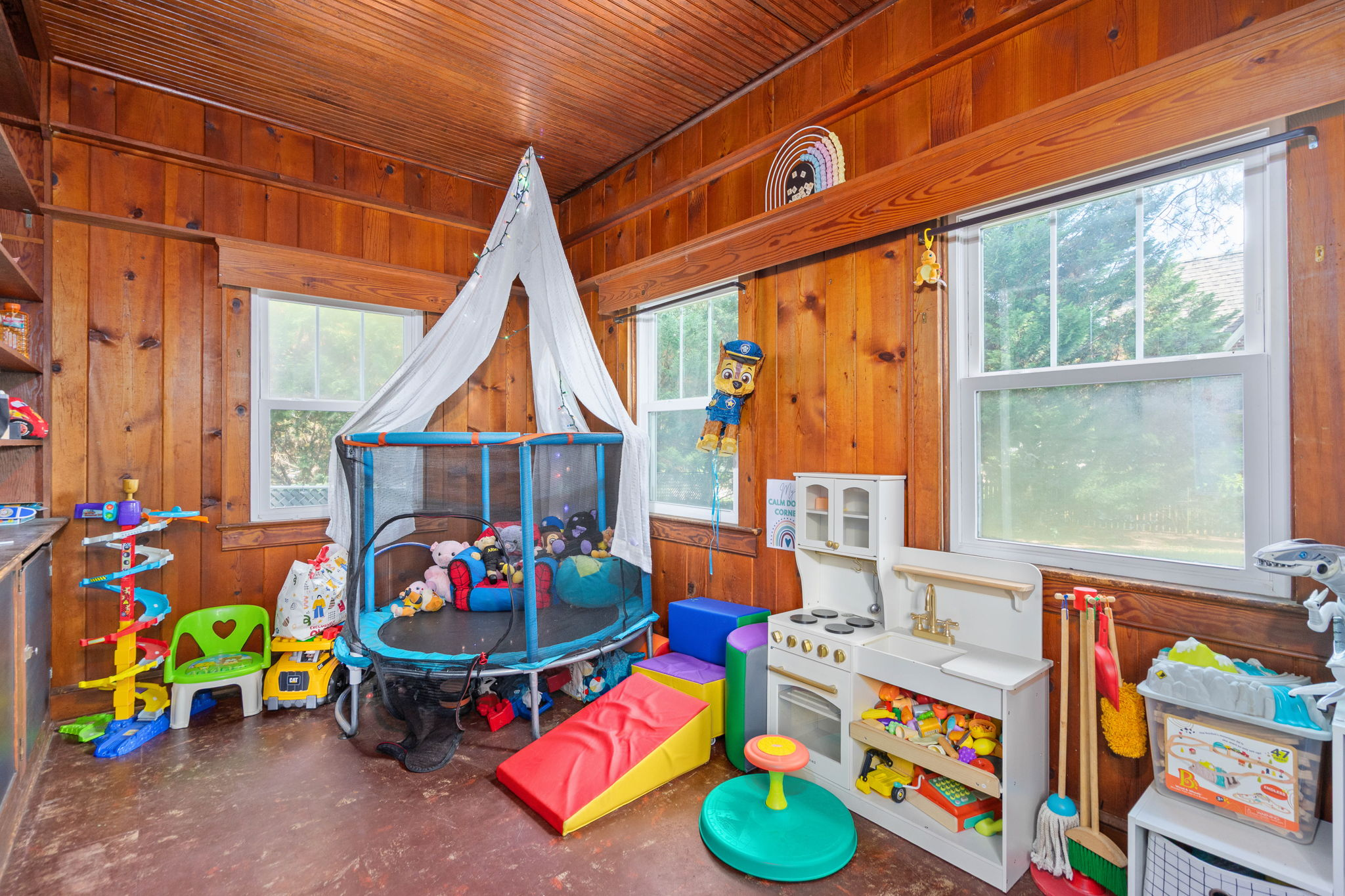 Flex room with knotty pine paneling and wood slat ceiling