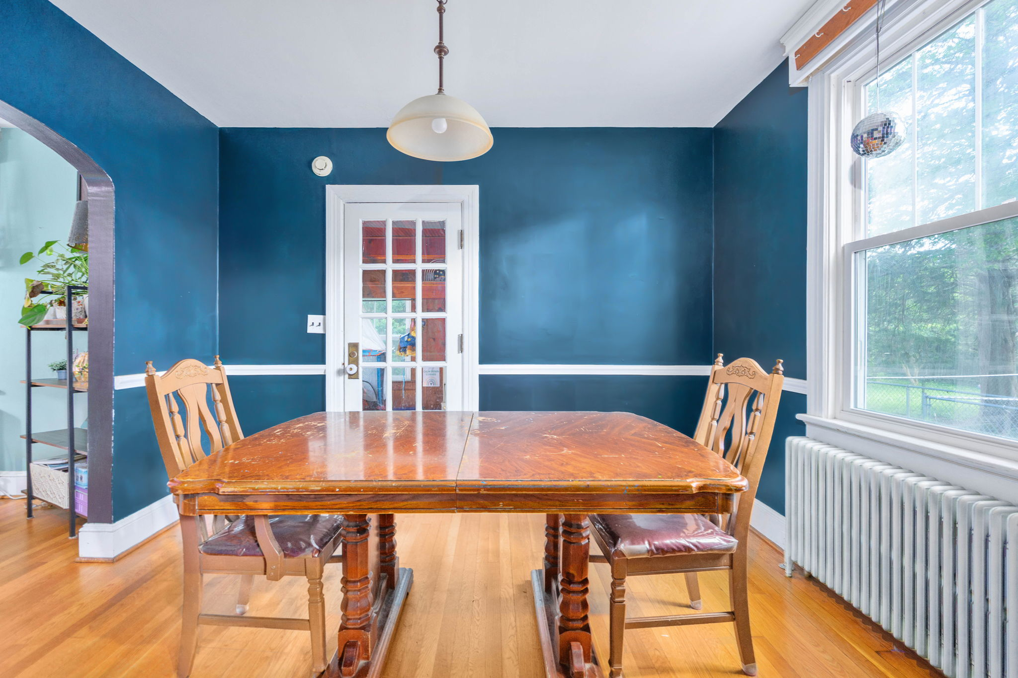 Dining room with blue accent walls and hardwood floors